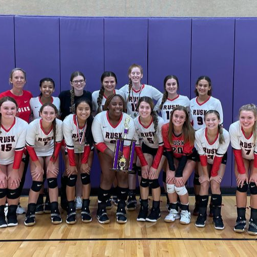 girls volleyball team with trophy