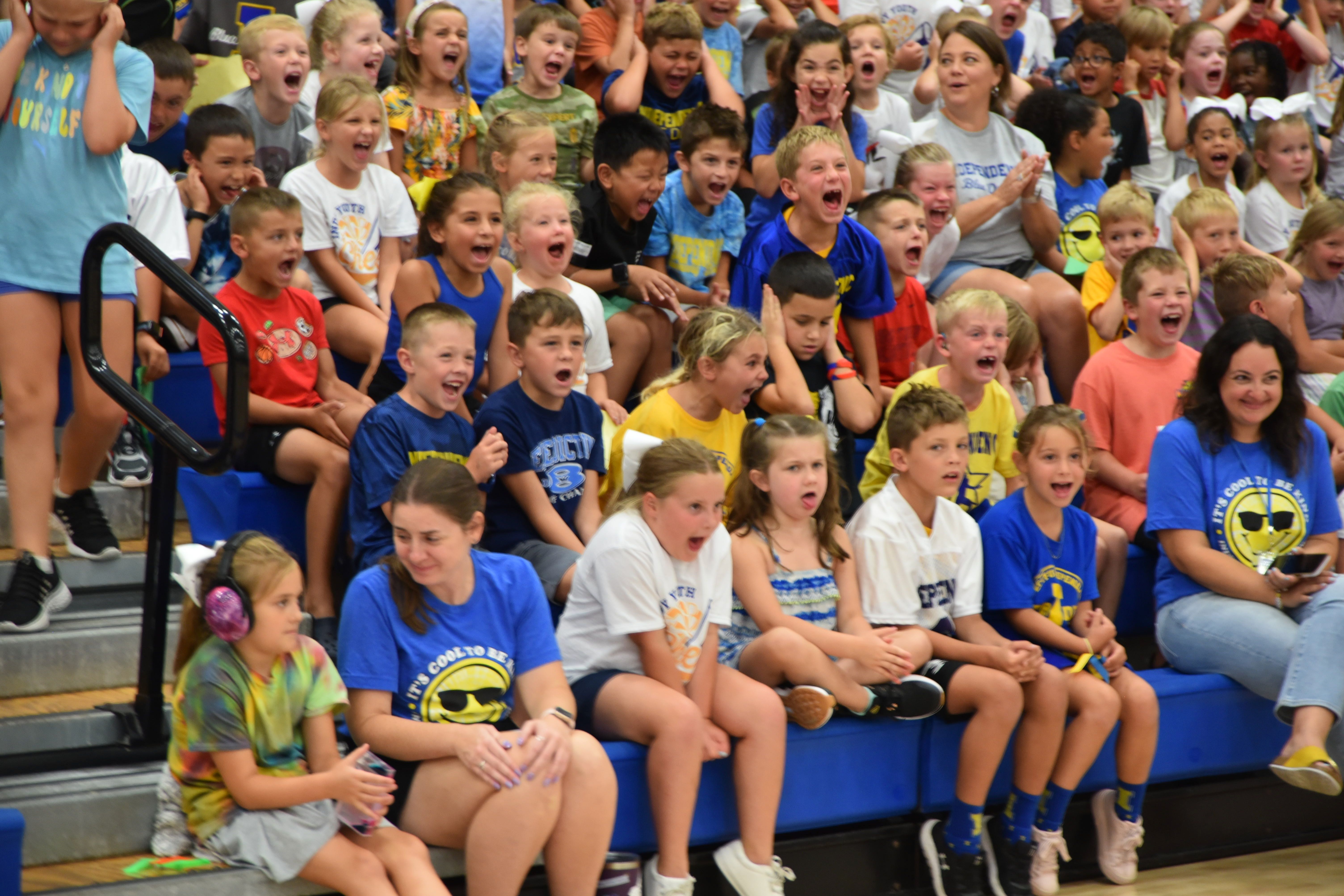 students cheering at a pep rally
