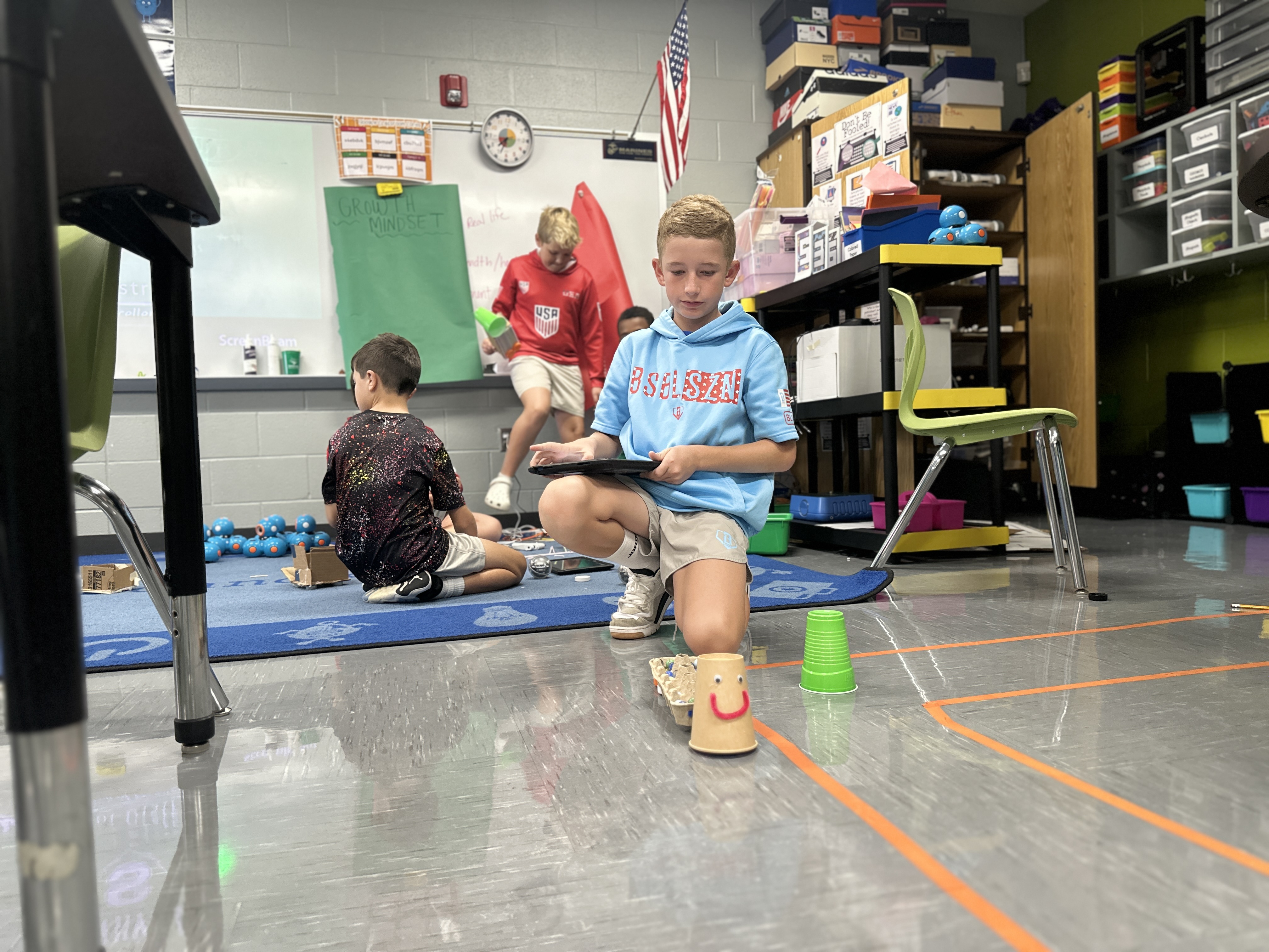 Student testing how many marbles the robot can haul