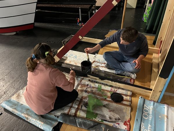 Theatre students paint set for musical