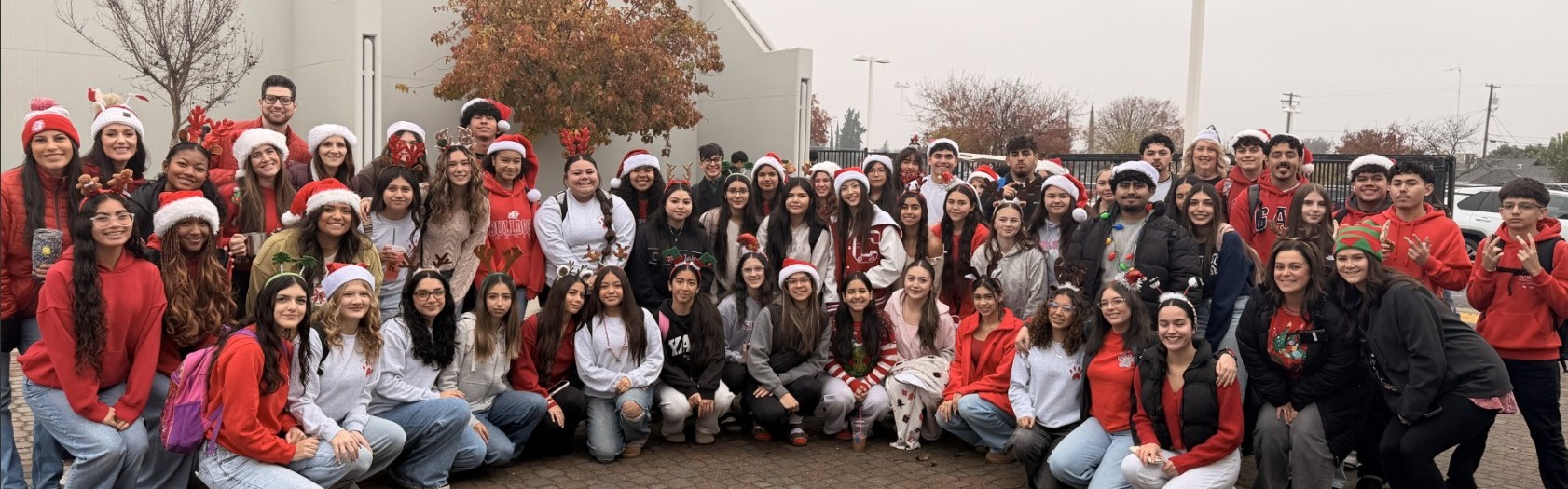students in a group wearing holiday gear 