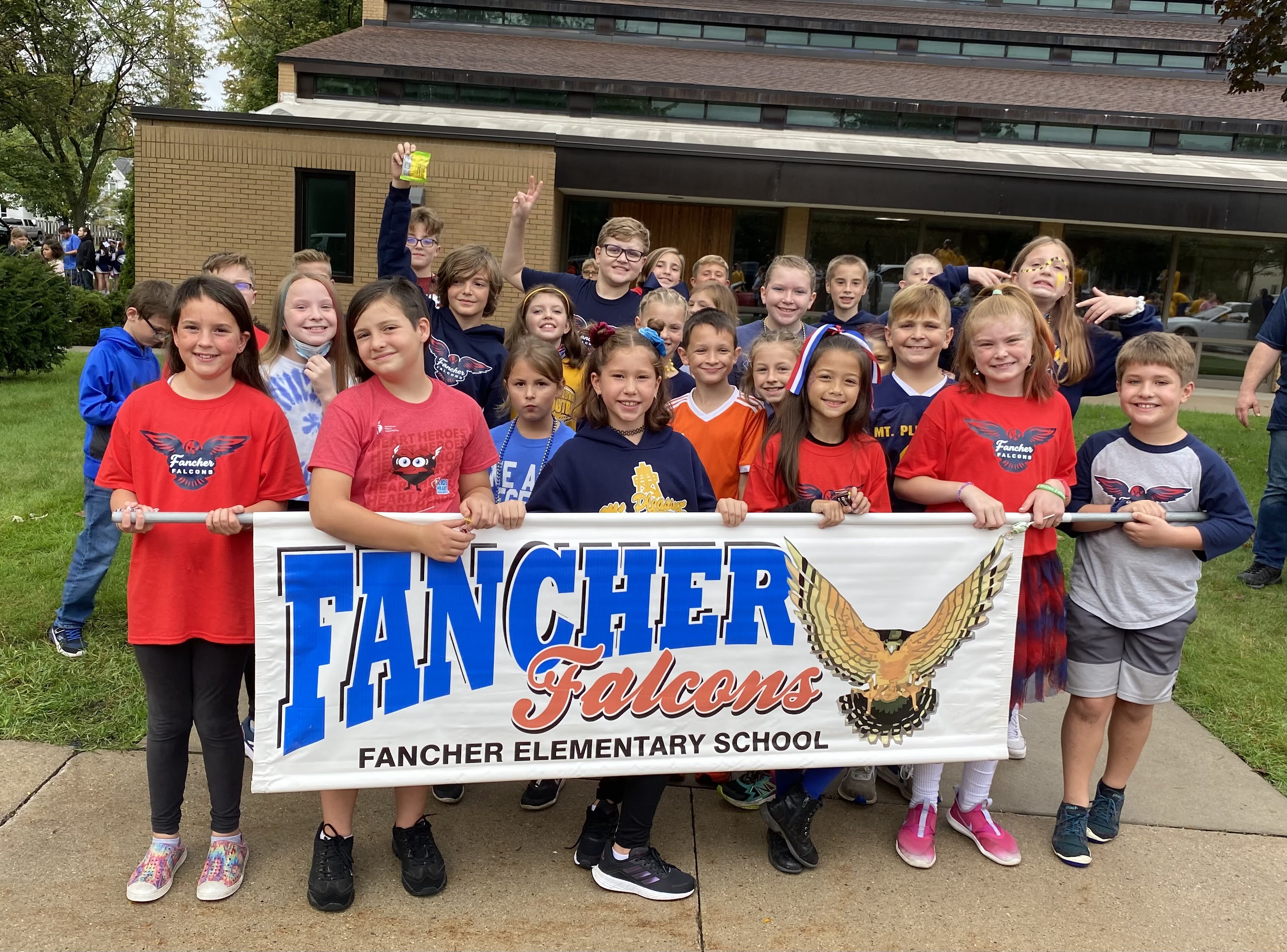Fancher students in the MPPS Homecoming parade with a Fancher Banner