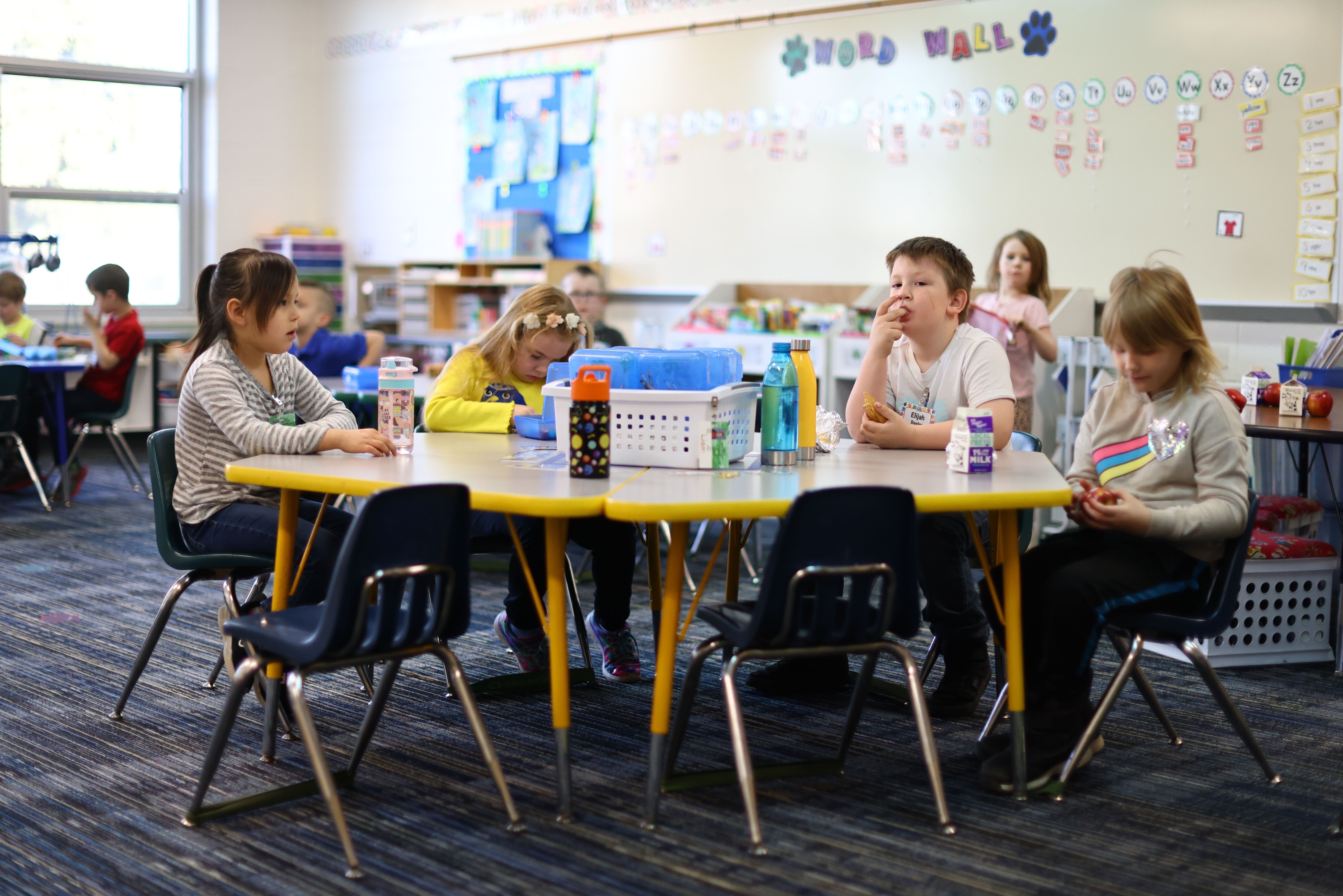 Ganiard Kindergarten Students eating breakfast at a table in their classroom. 