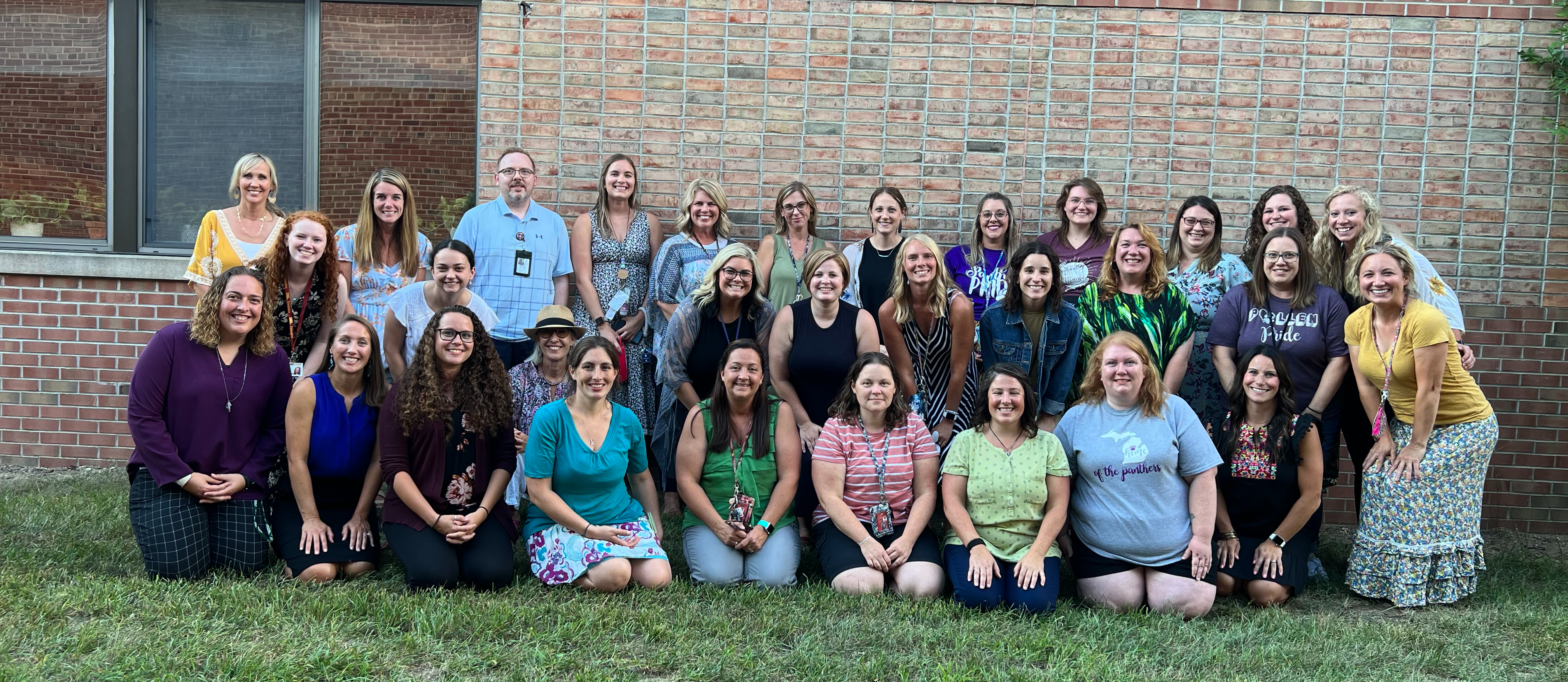 The group of Pullen Teachers posing outside the school building.