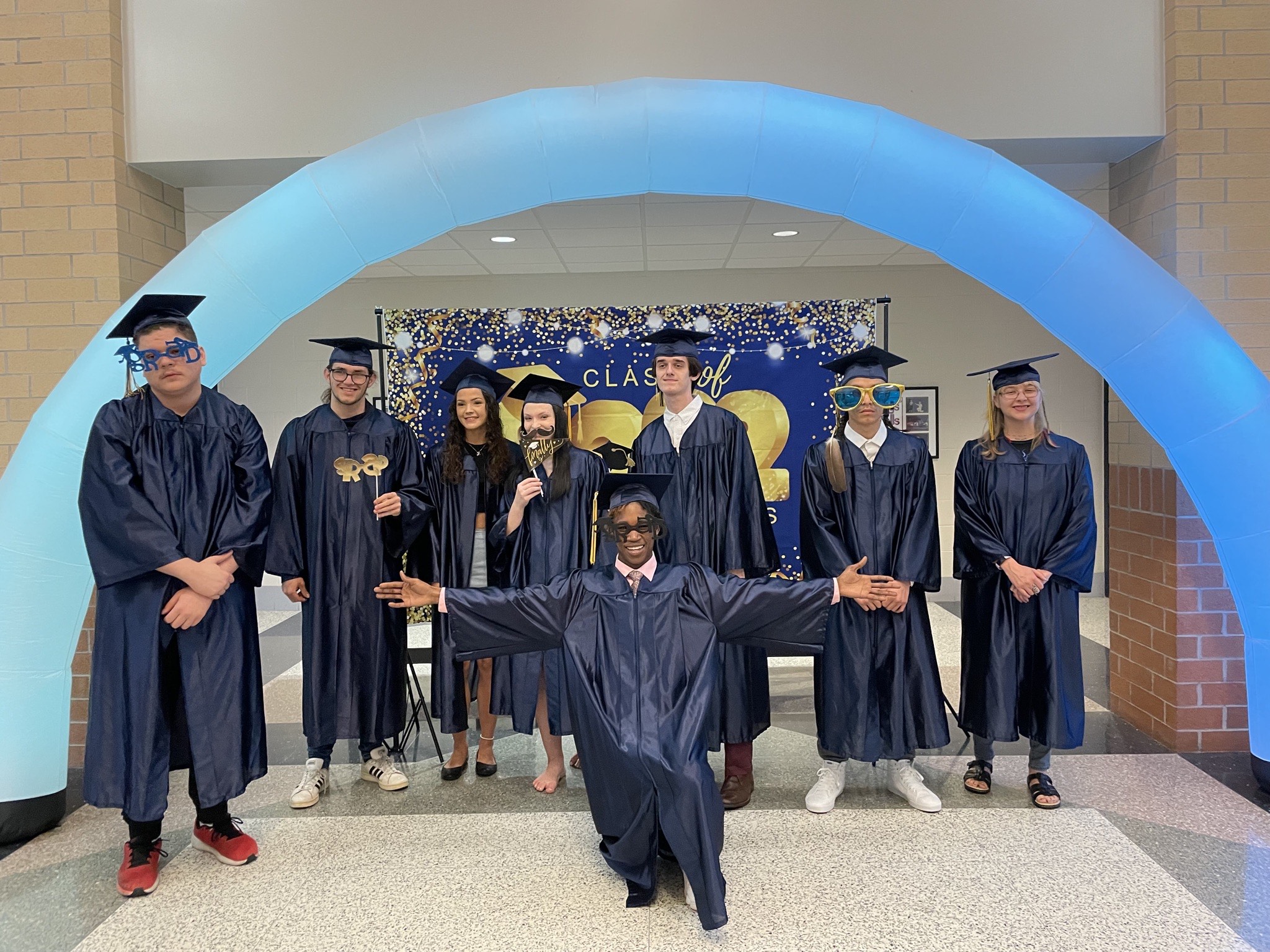 WAY and Adult Education students celebrate graduation in their caps and gowns. 