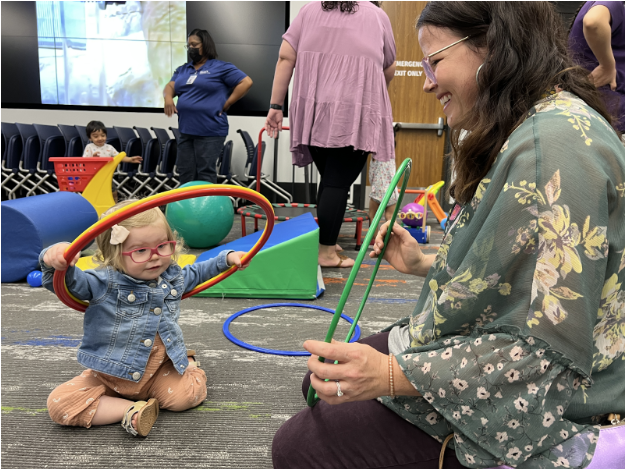 teacher with a little kid playing with toys