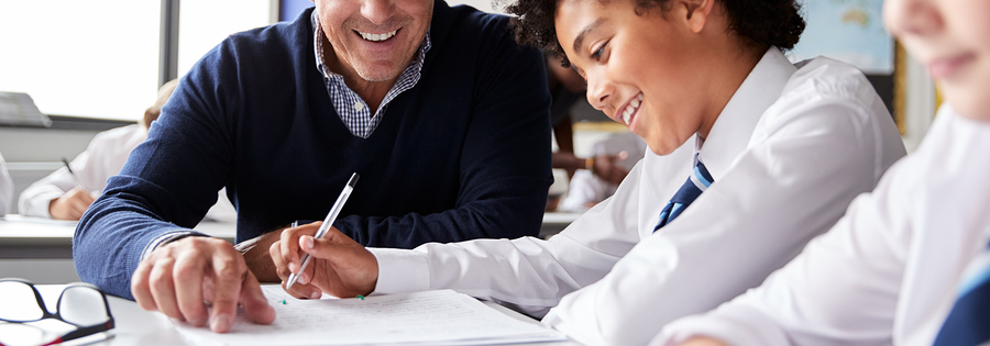 High School Tutor showing a student something on paper