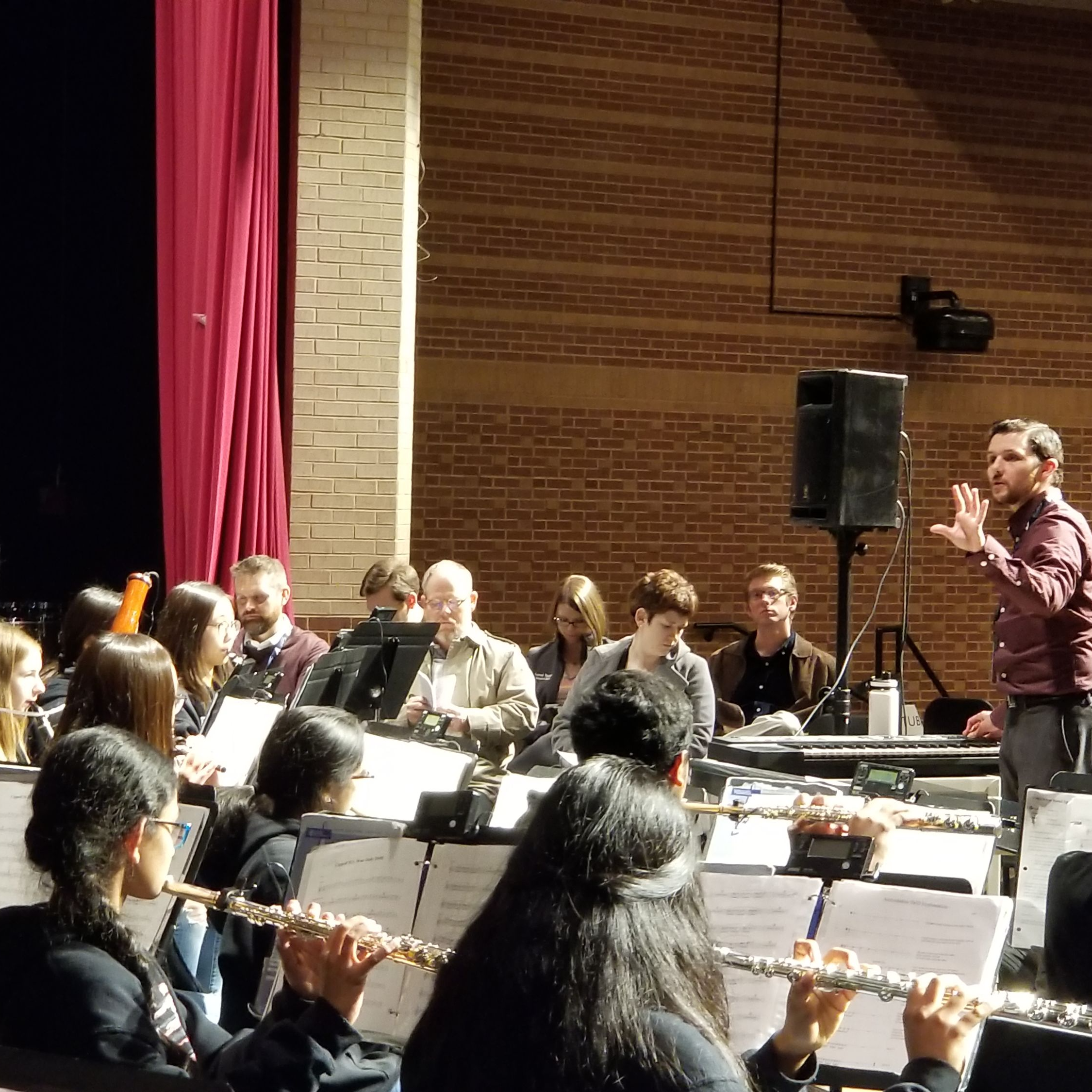 music teacher directing an orchestra