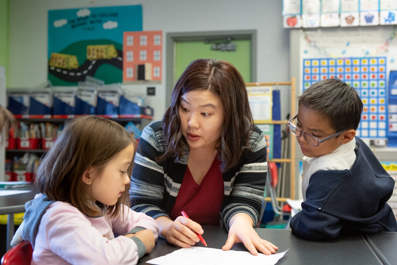 teacher at a classroom teaching to students