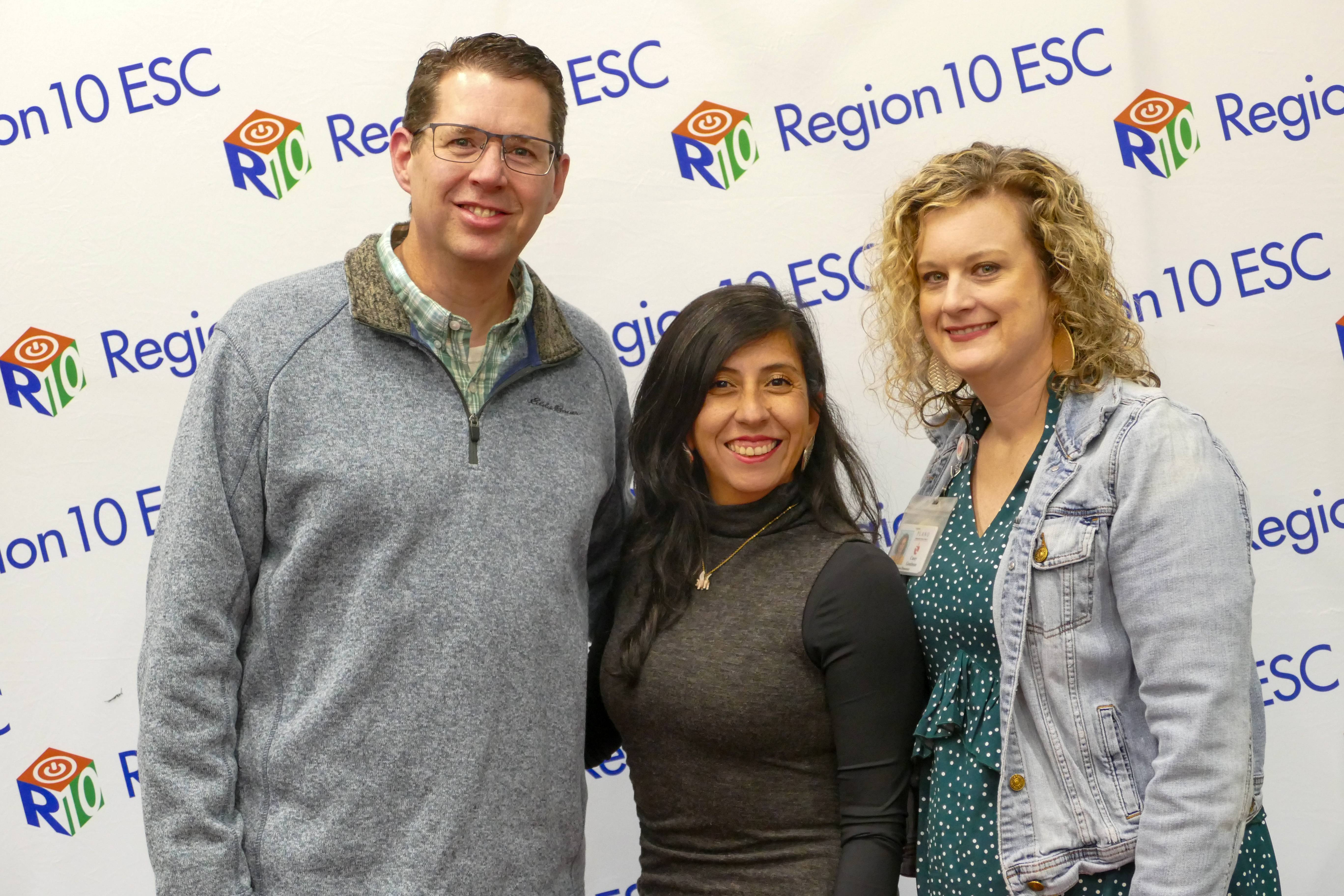 A group of teachers standing in front of R10 banner. Nationally Board Certified Teacher