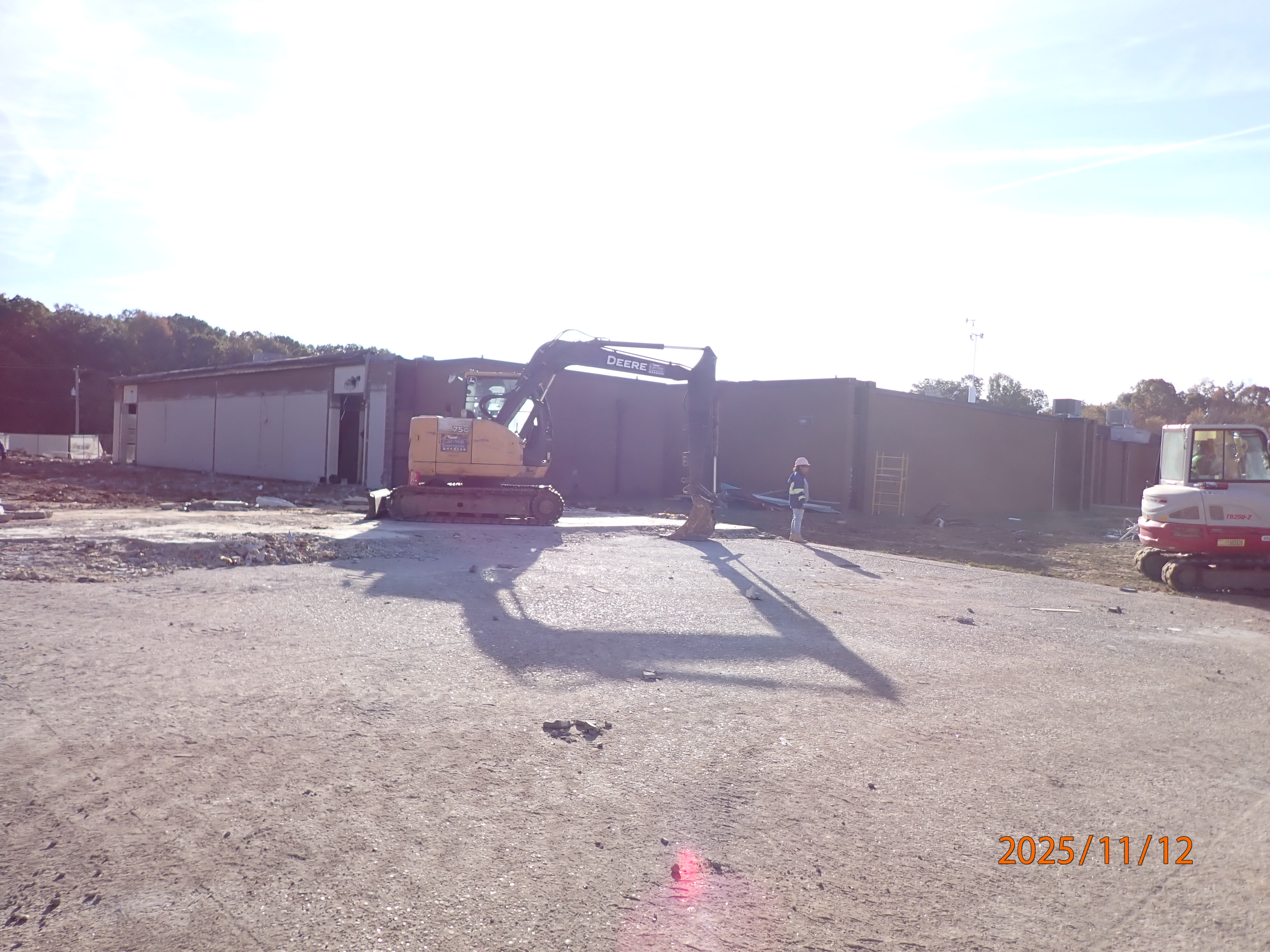 Construction crew continuing to demolition the building and slab.