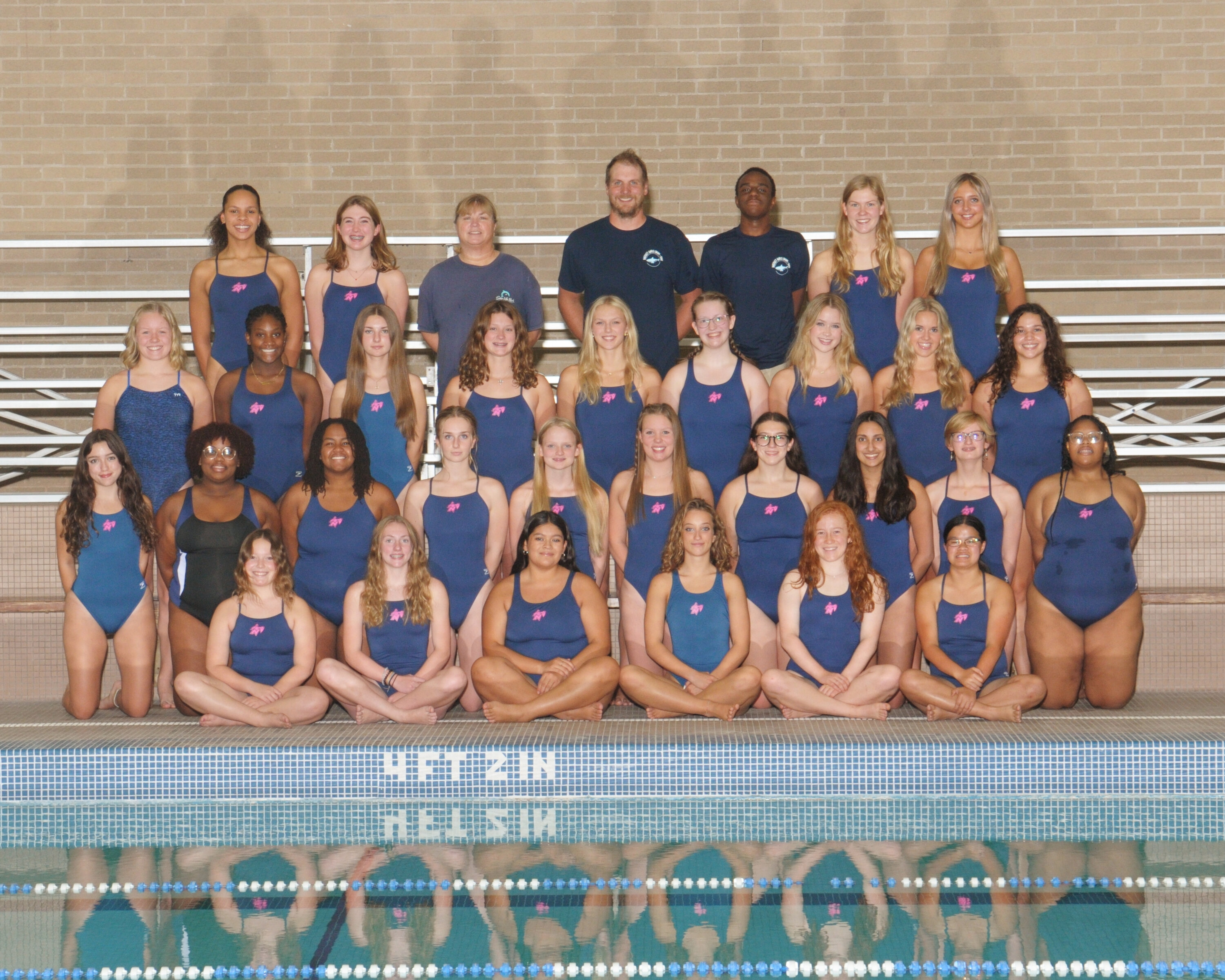 picture of the nicolet girls swimming team posing for a picture in the water
