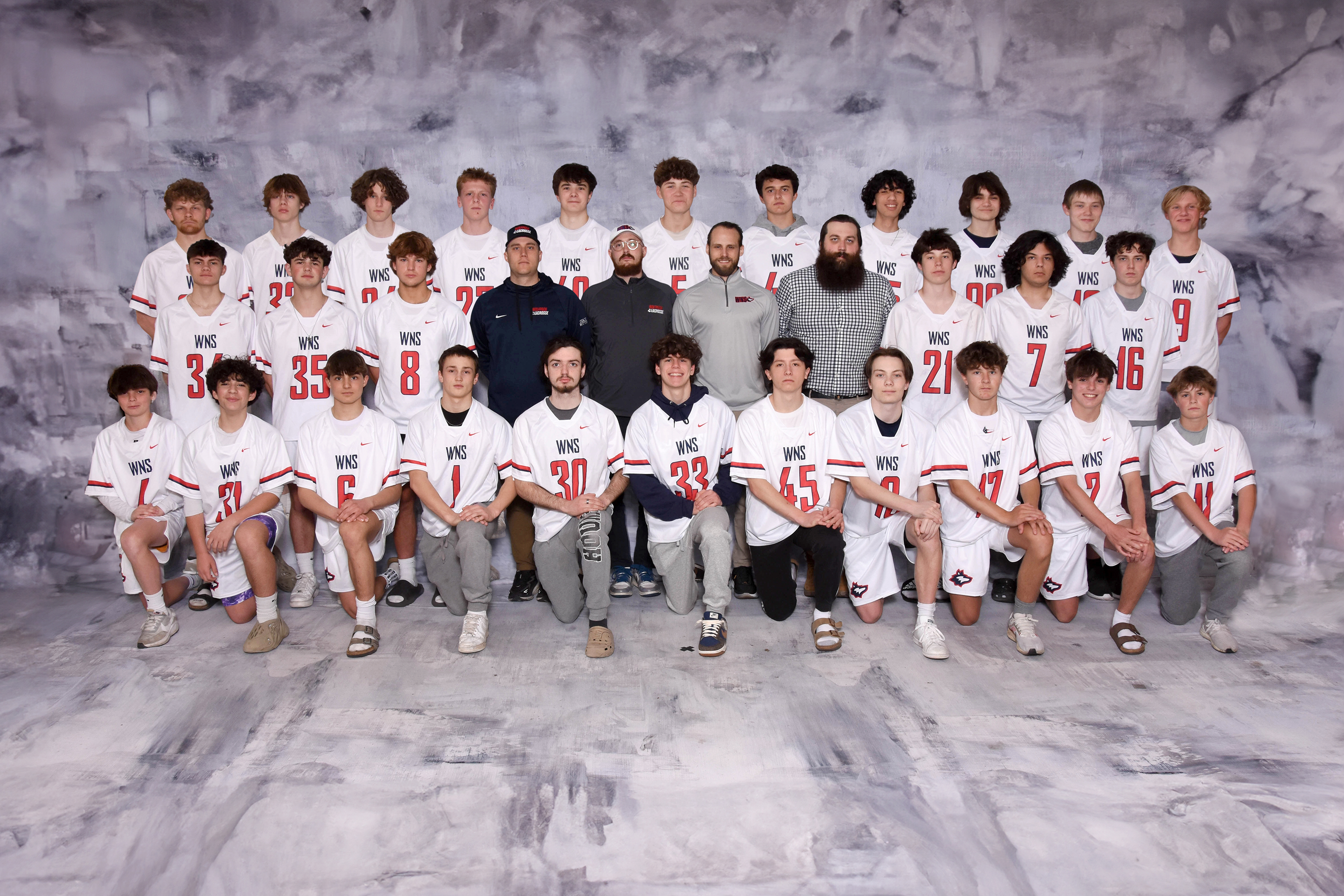 varsity boys lacrosse posing for team picture