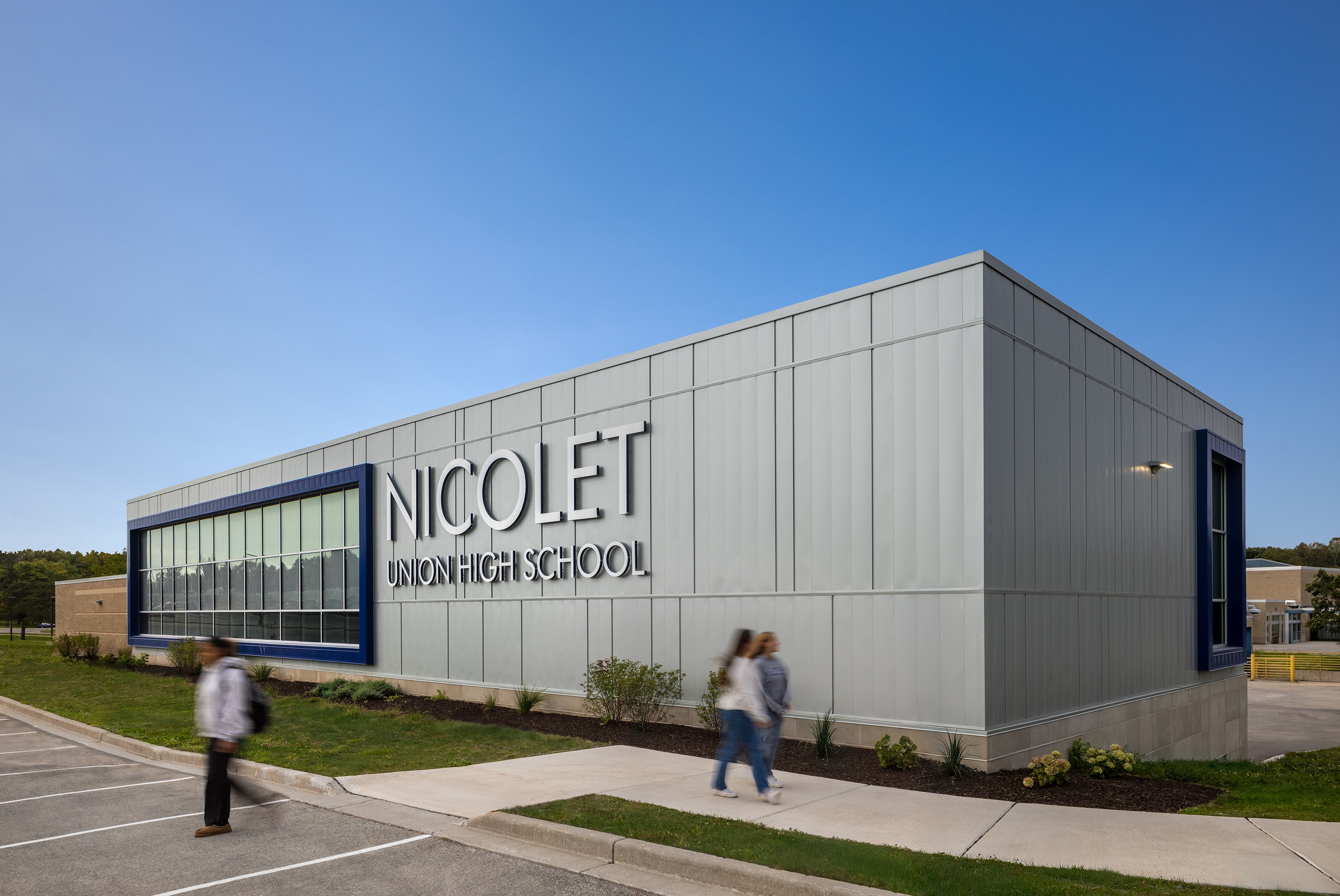 picture of students walking in front of school