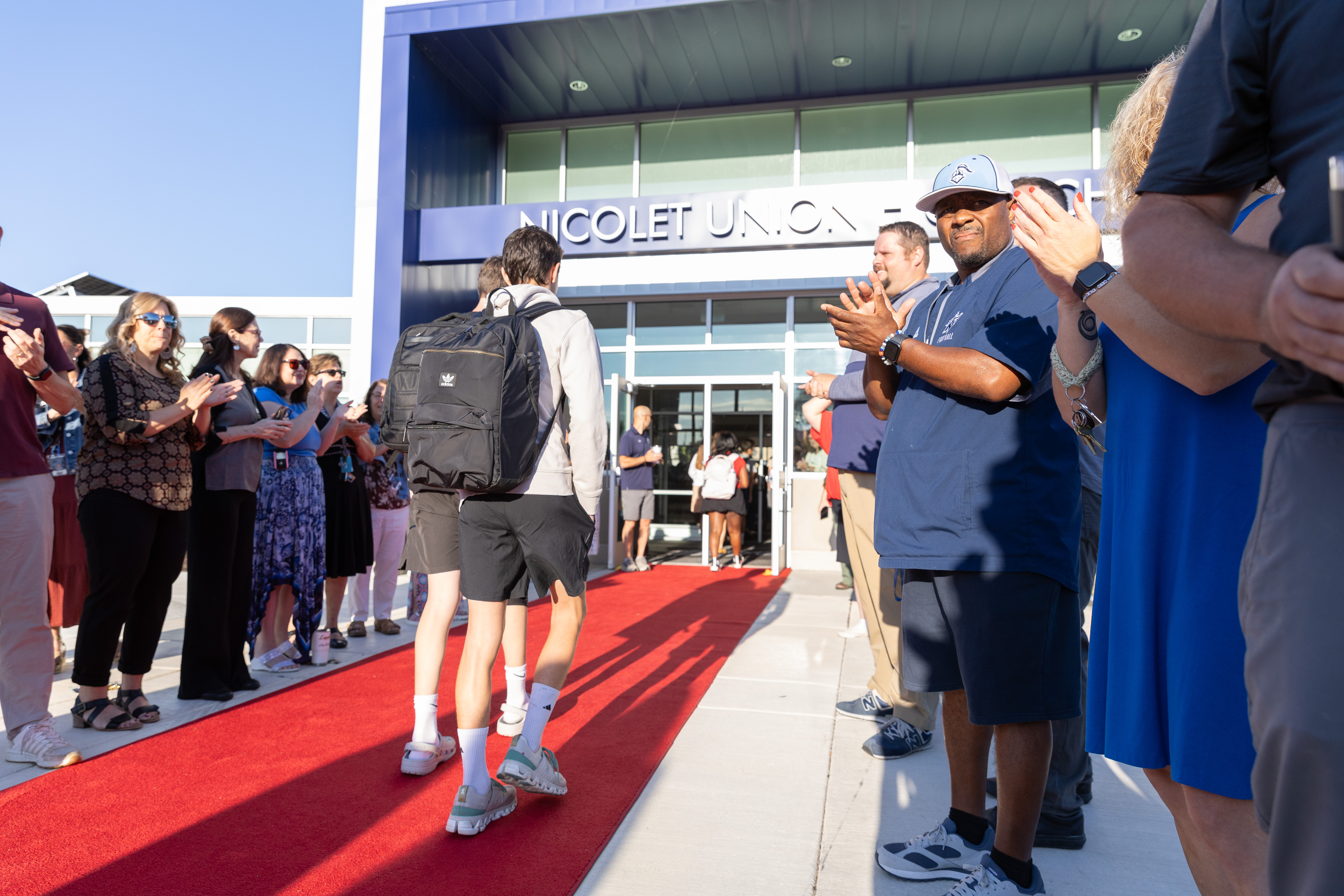 a picture of a student walking down the red carpet