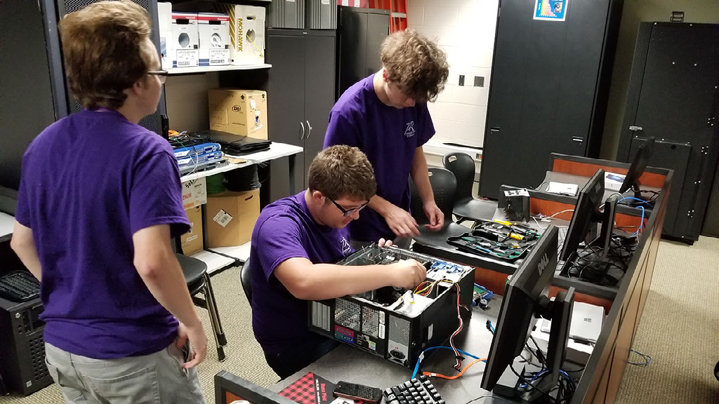 Students work on assembling a computer.