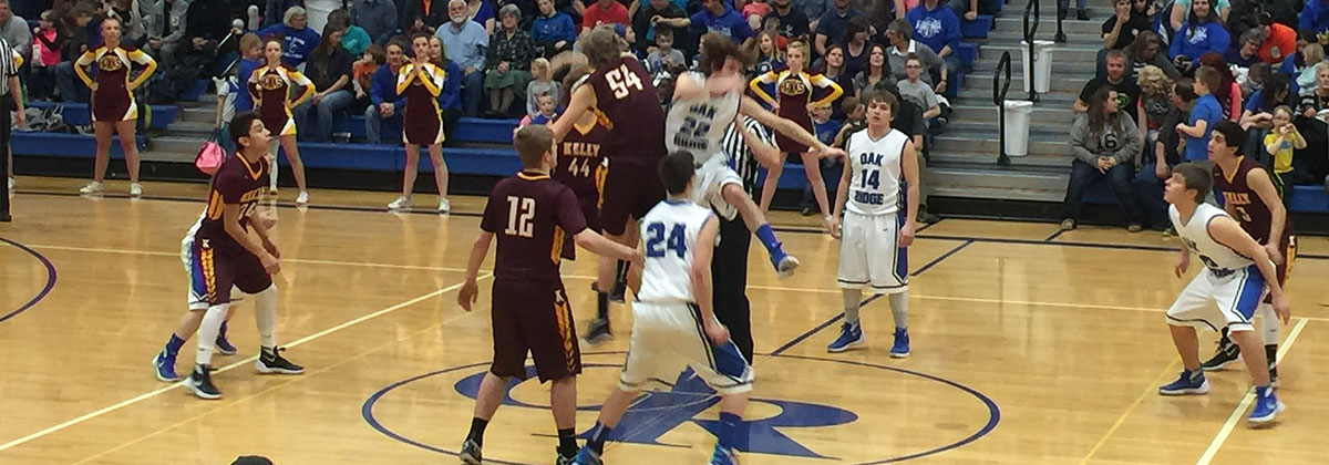 Basketball players participating in game.
