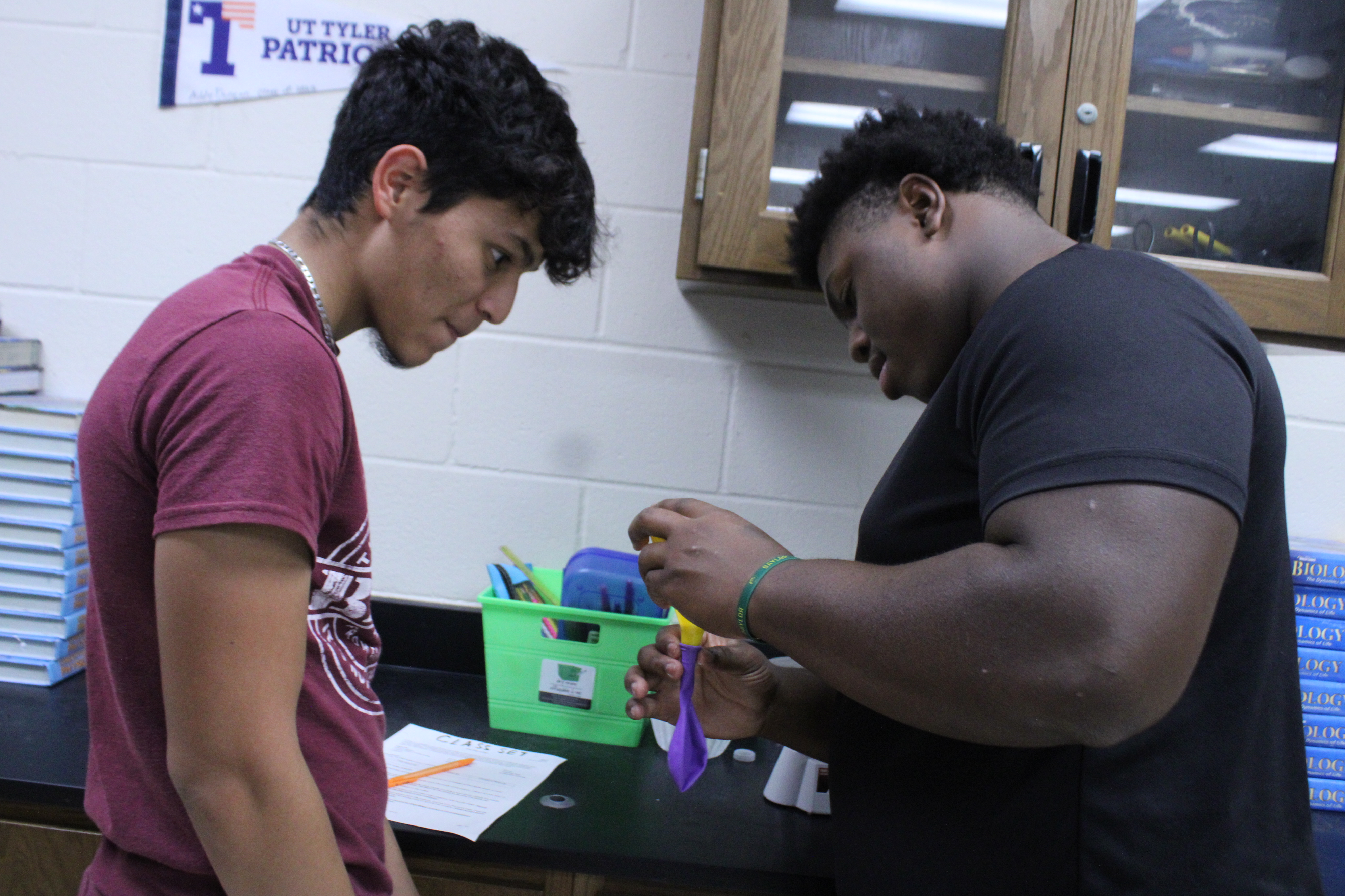 Two students working on a chemistry class experiment together. 