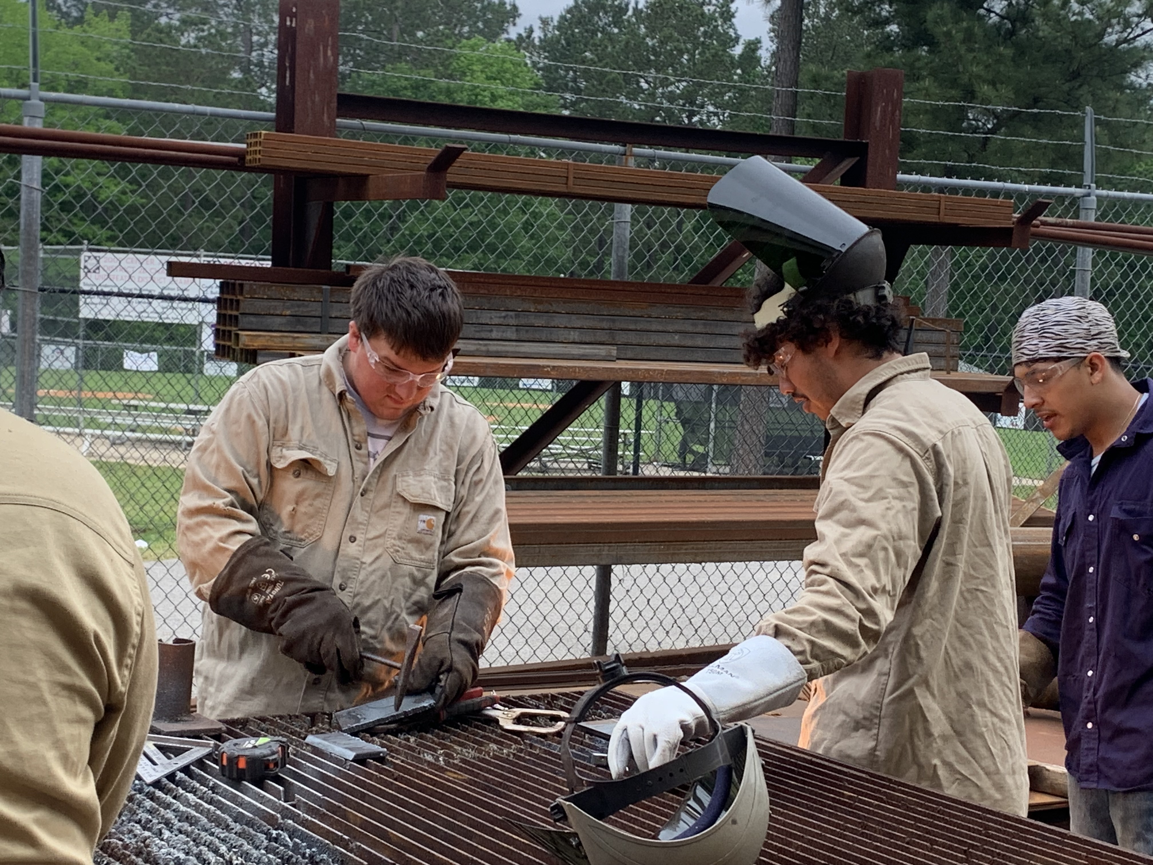 Two dual credit students in welding class working on a welding project.