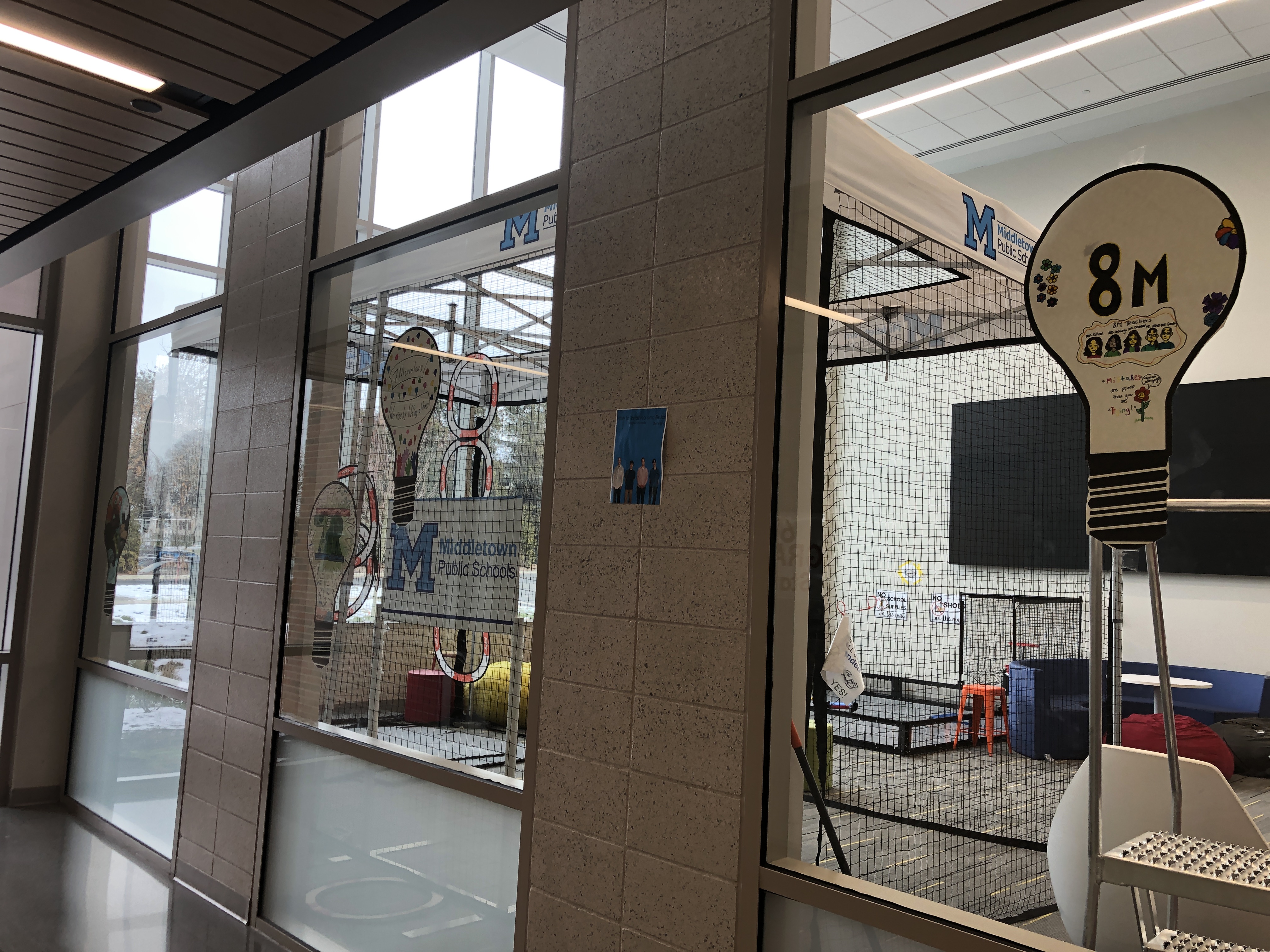 view of the Innovation Center from the hallway, looking at light bulbs decorated by students