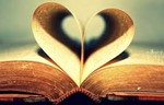 an open book with its central pages bent inward to form a heart