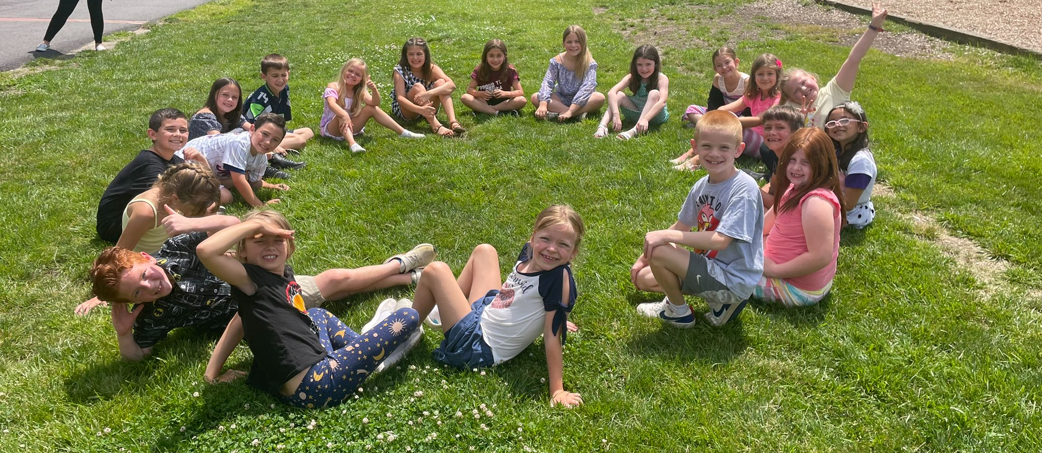 students sitting in a field