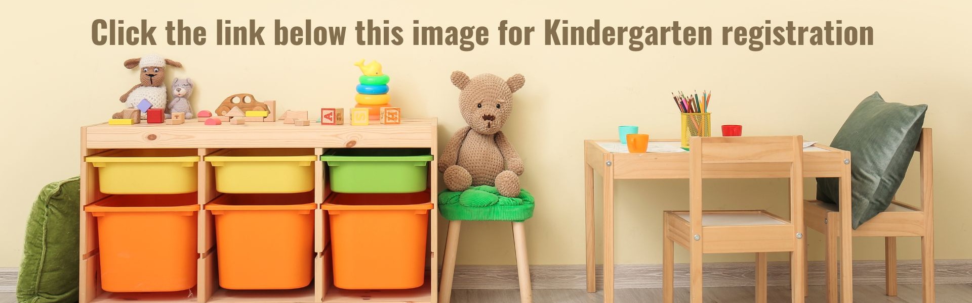 image of a kindergarten classroom with a table and chair, toys, and an organizing bins. Click the link below this image for Kindergarten registration