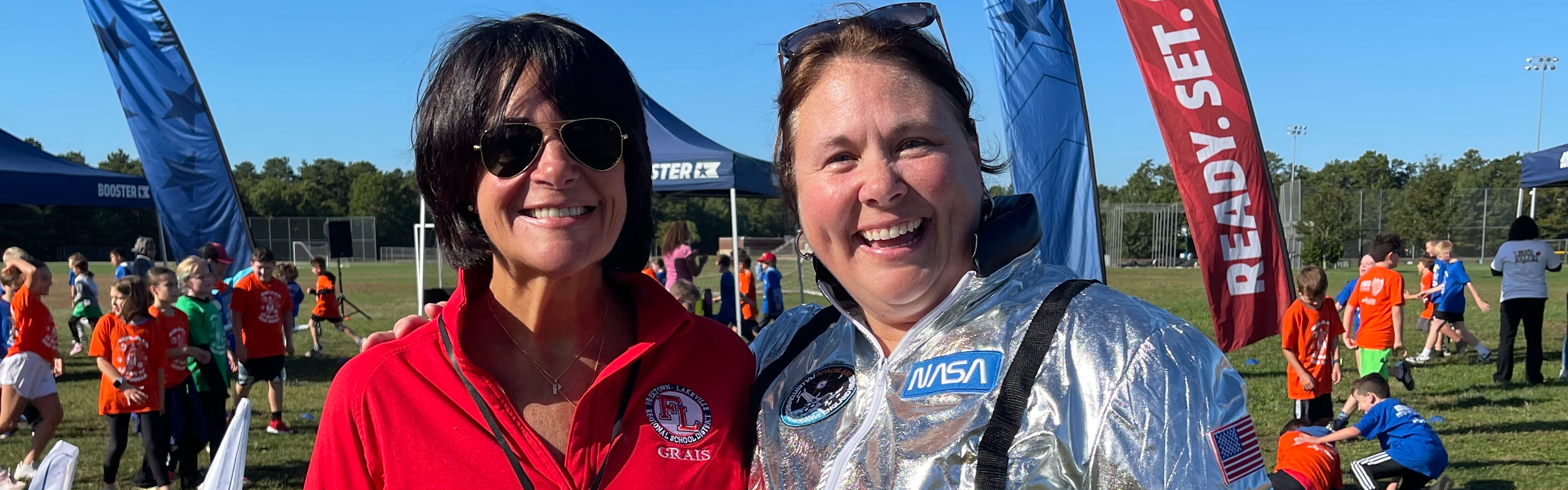 The principal posing with a teacher at the fun run.