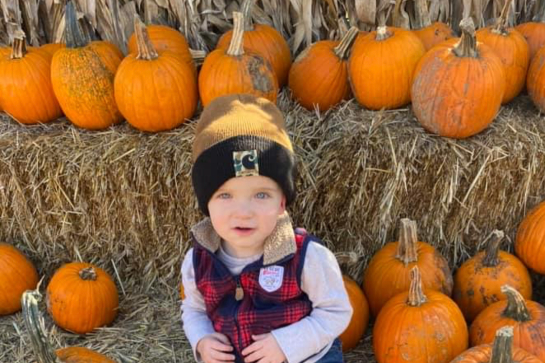 Toddler with pumpkin