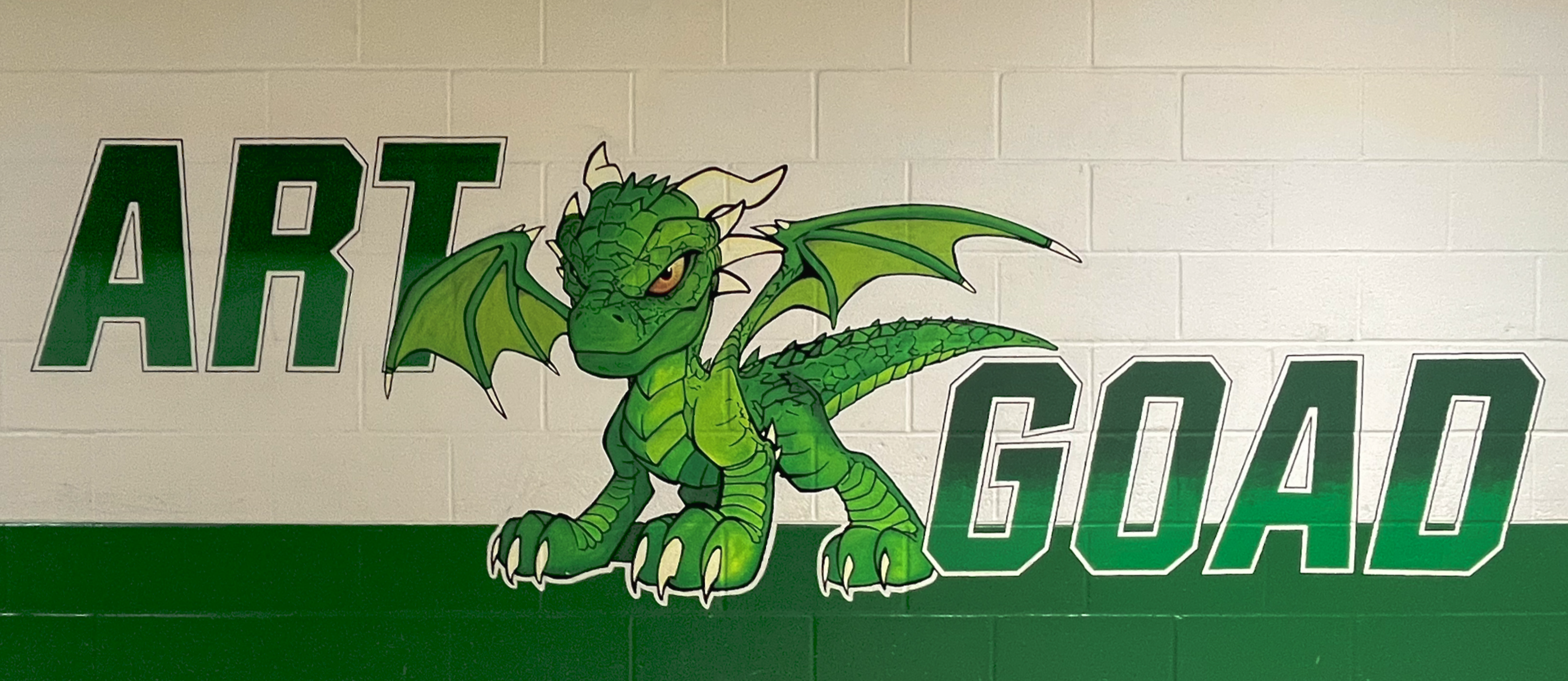 Young dragon mural painted on wall with the words Art Goad.