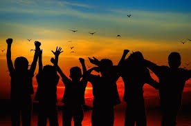 kids in front of sunset jumping in the air