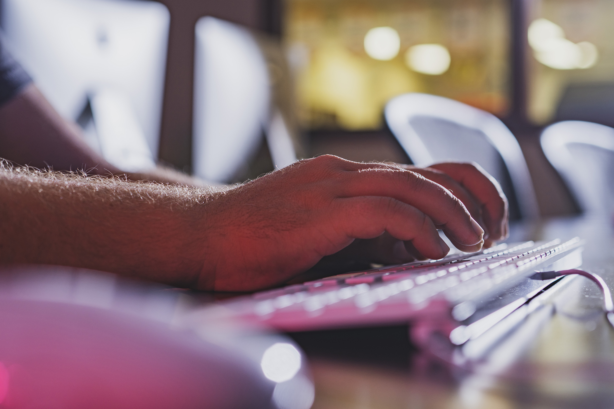 Hands typing on a keyboard