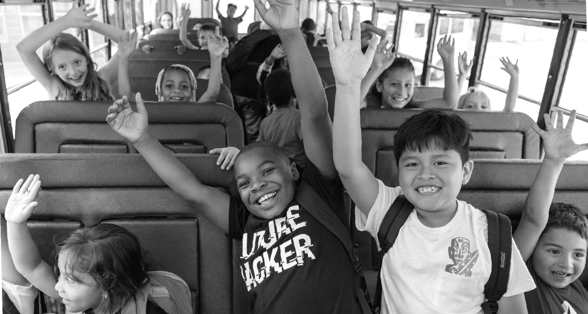 students smile on school bus