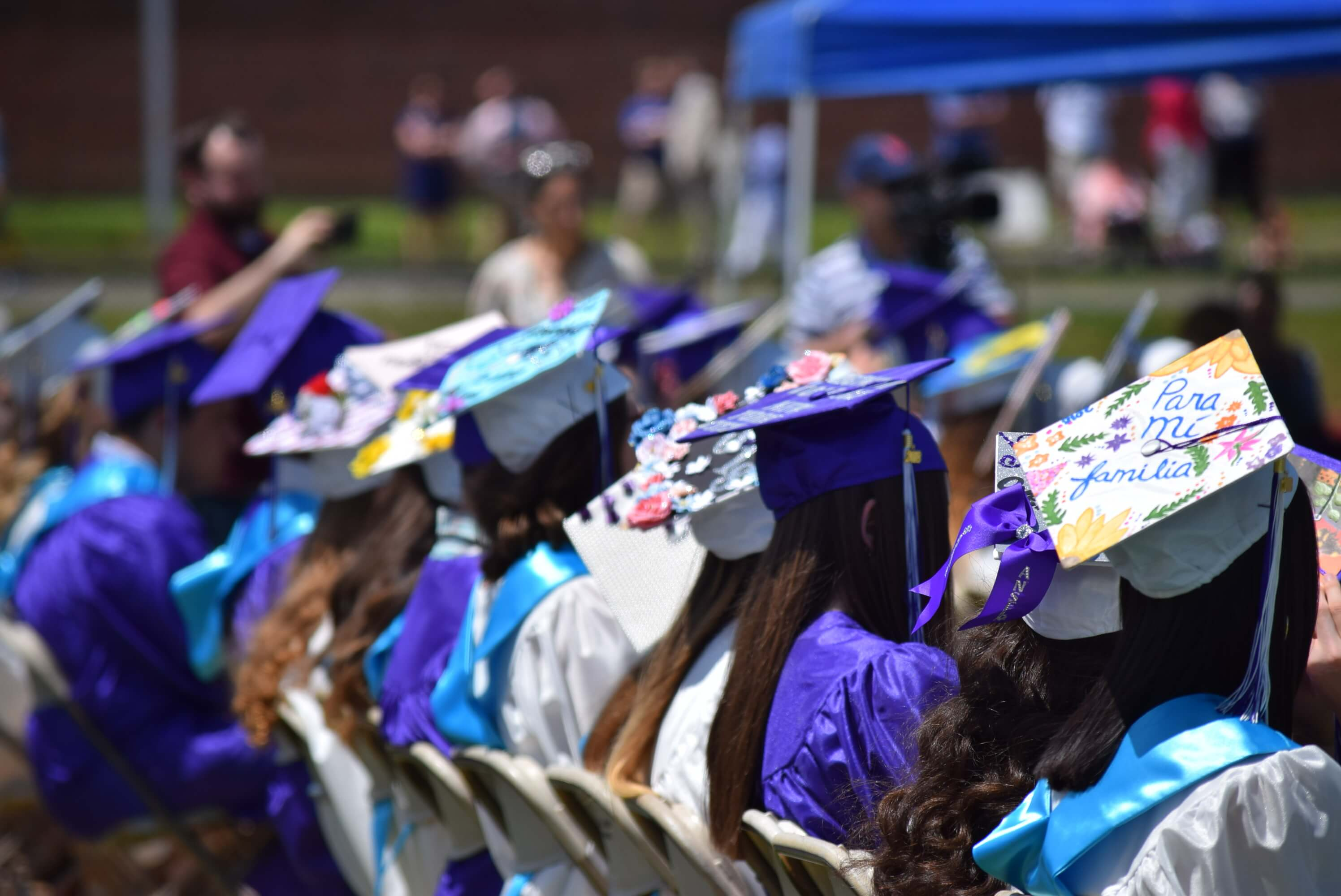 Students wearing decorated graduation caps.
