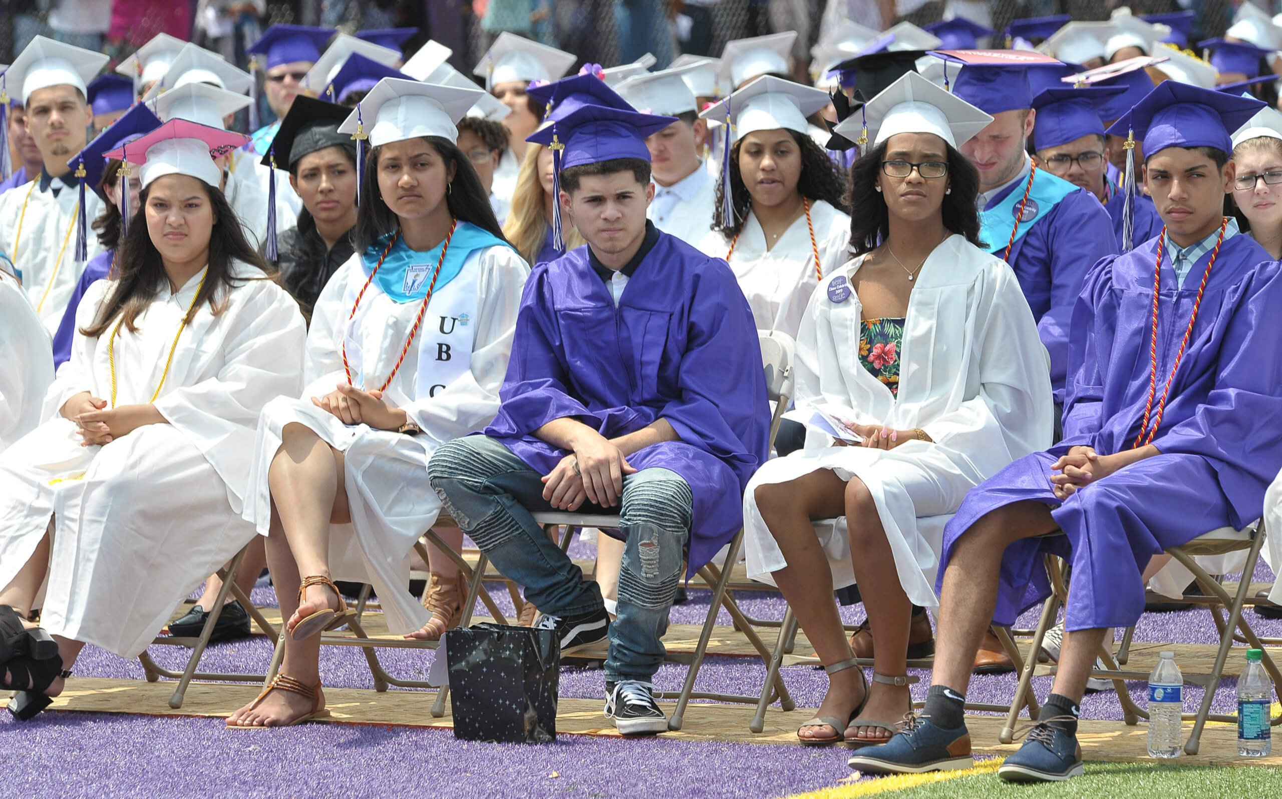Students dressed in their cap and gown at graduation.