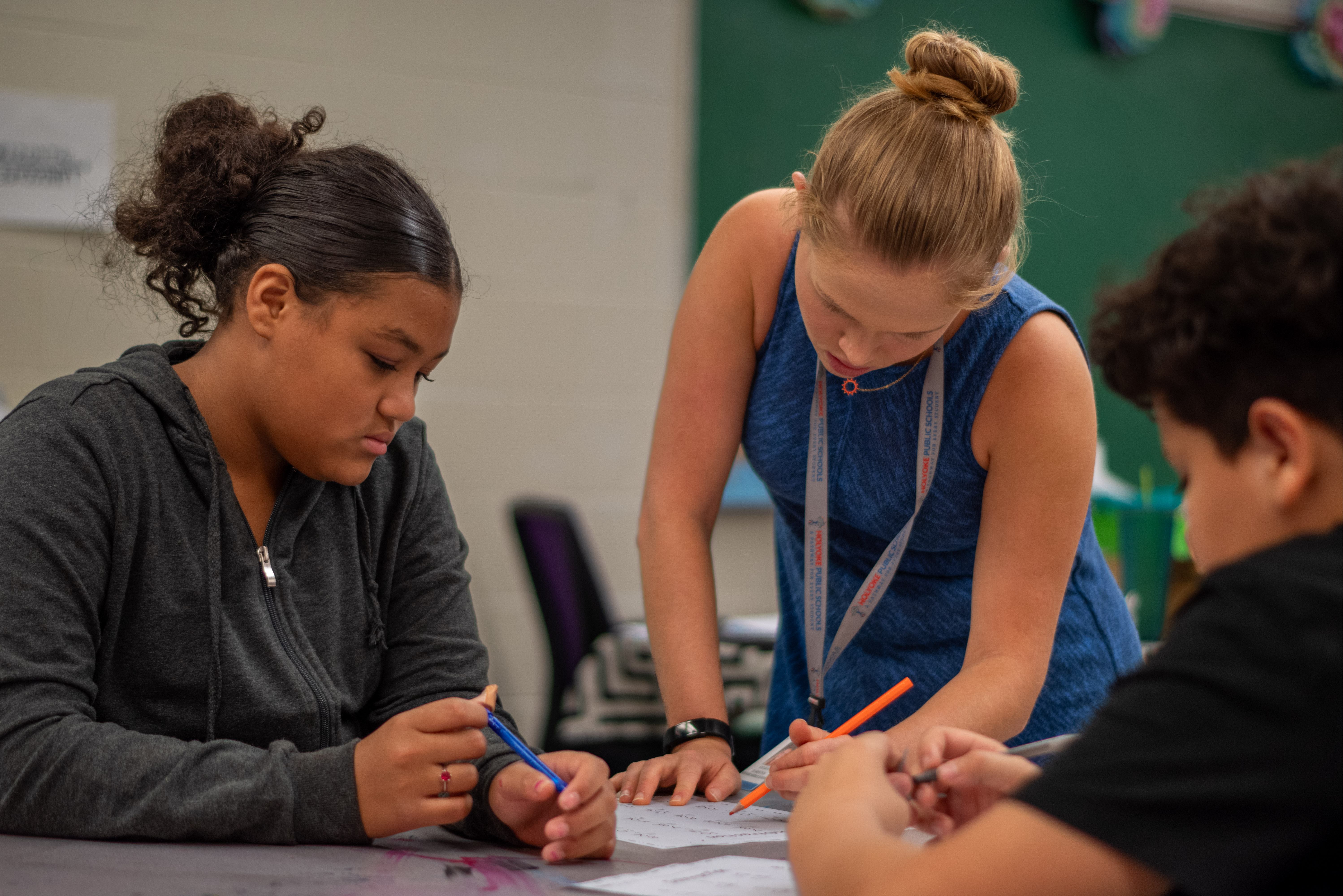 Teacher supporting students in class. 