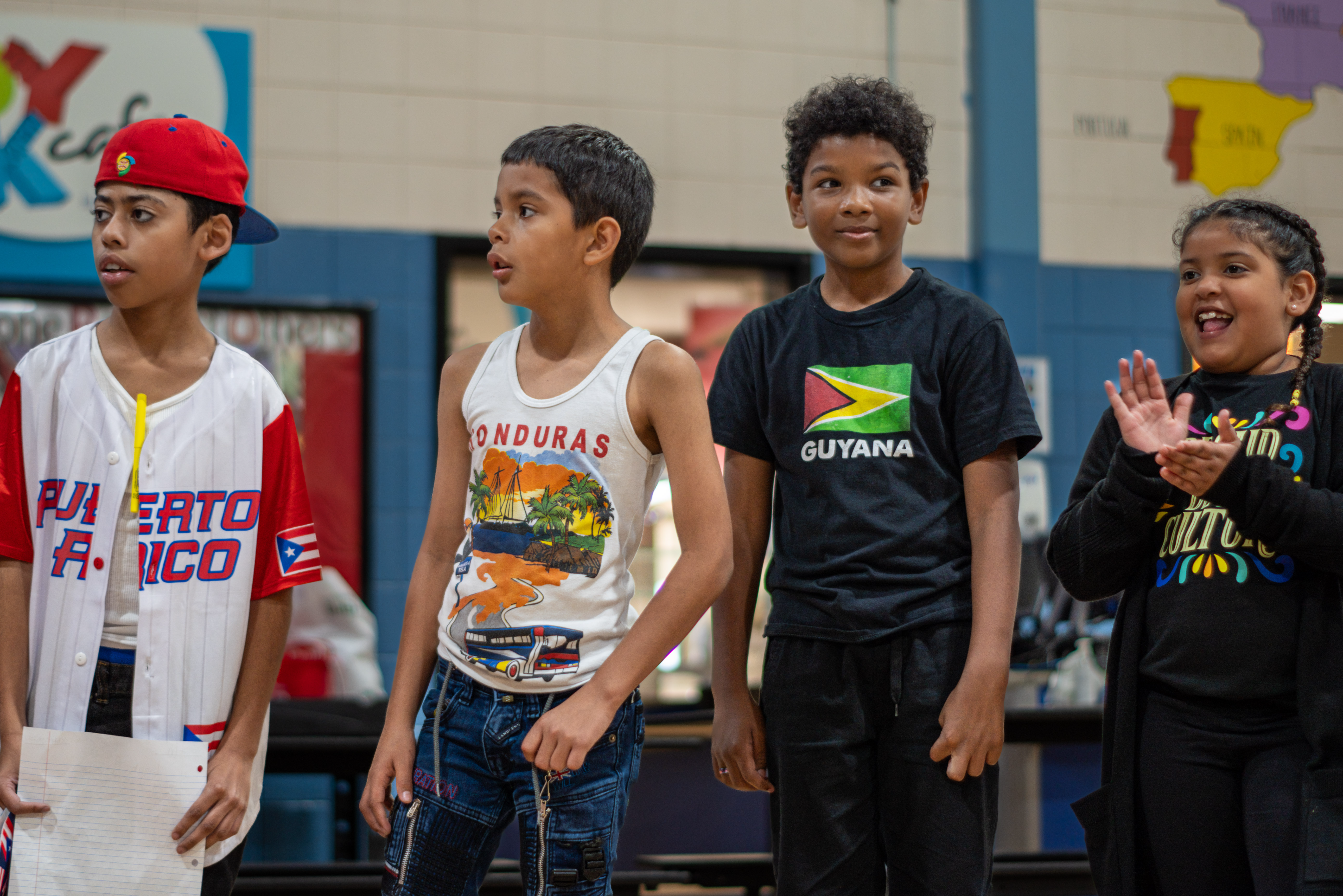 Four students next to each other with shirts from Puerto Rico, Honduras, Guyana.