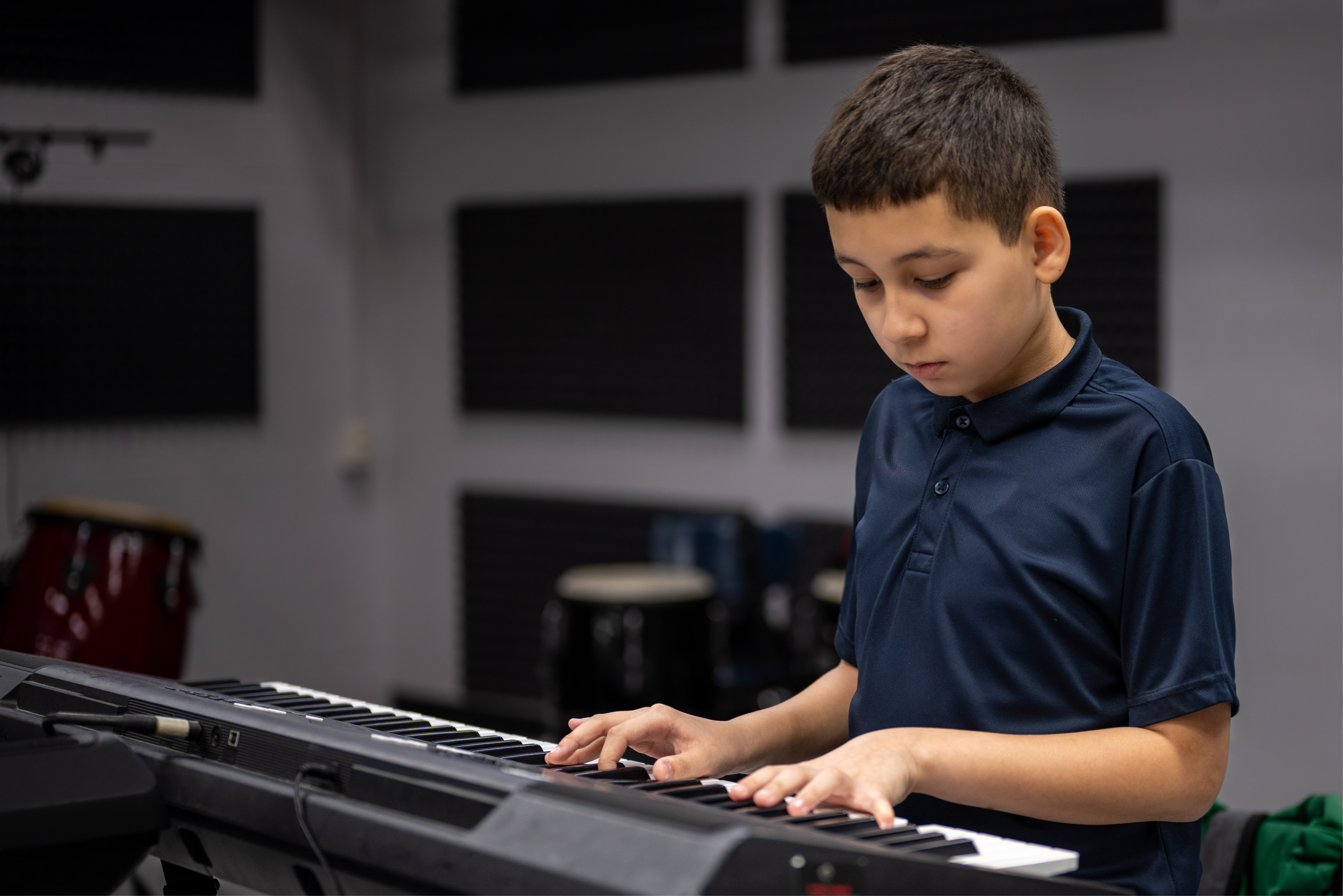 A middle school student playing the digital piano.