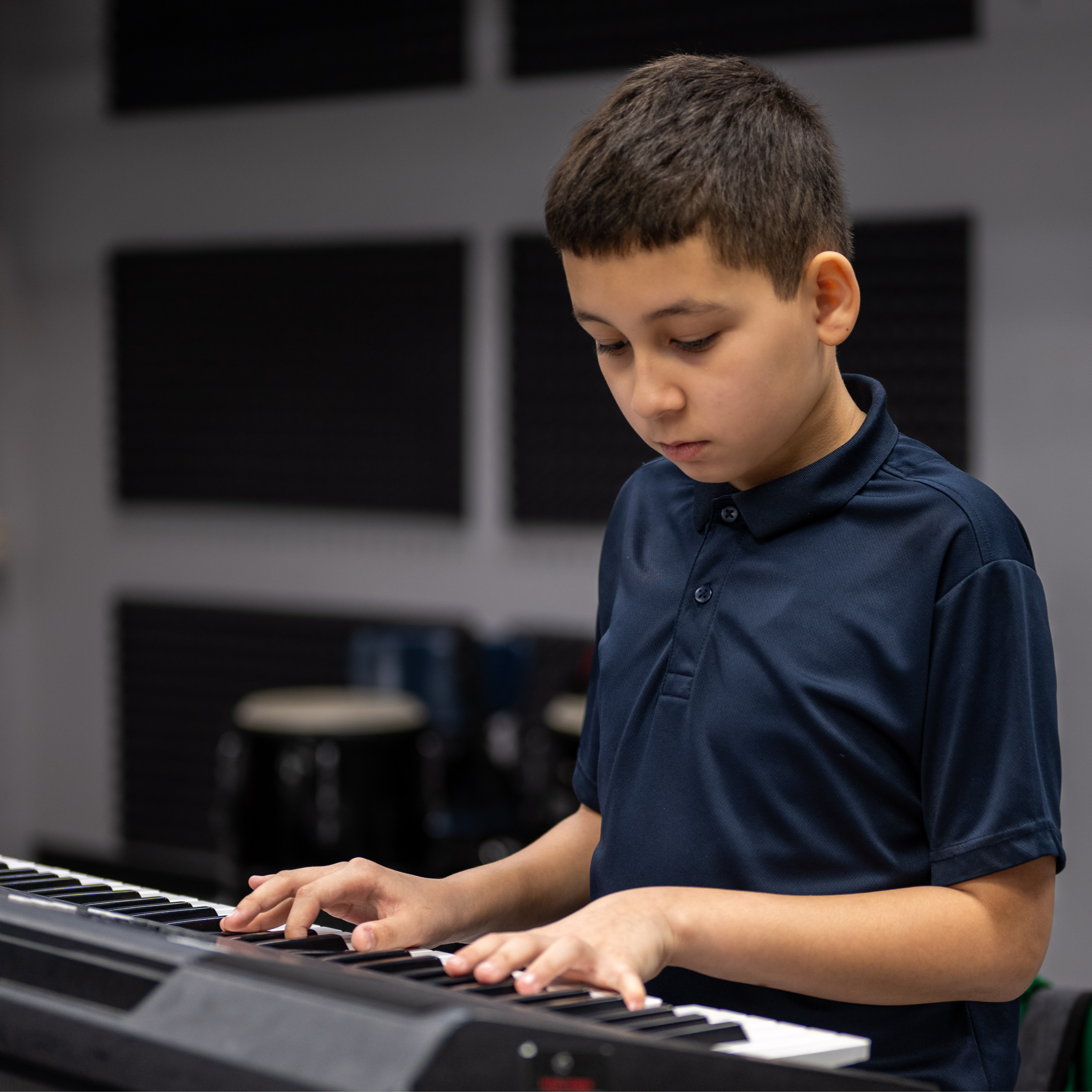 A middle school student playing the digital piano.