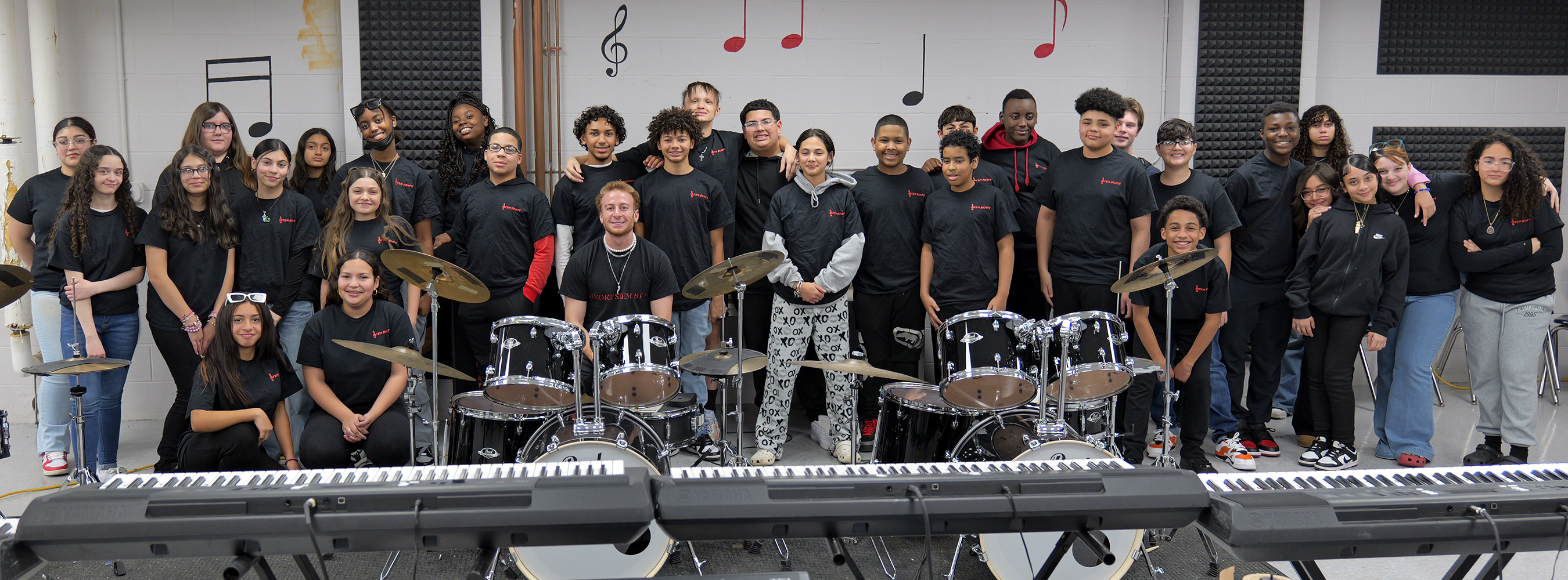STEM Academy music students in front of keyboards