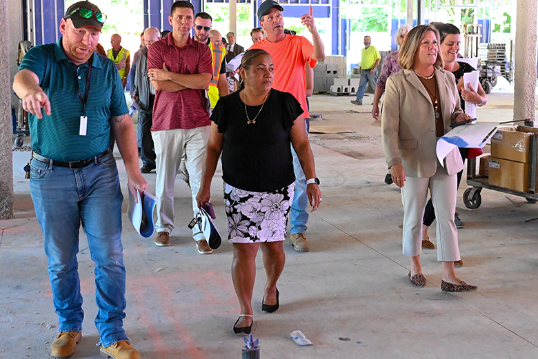 tour group walks through construction site