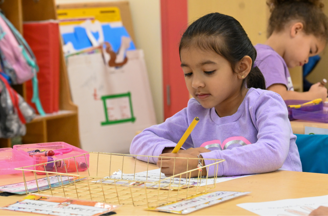 An E.N. White kindergarten student practices her handwriting