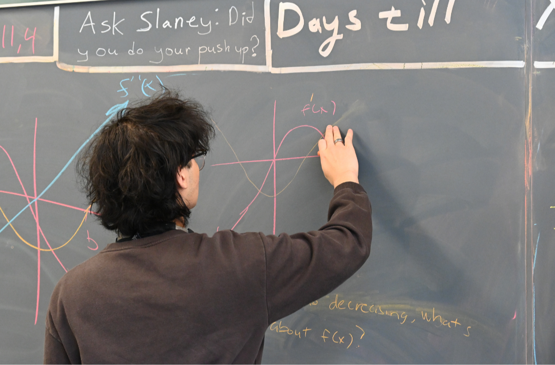 A student in Mr. Slaney's AP Calculus class  works through a problem on the blackboard