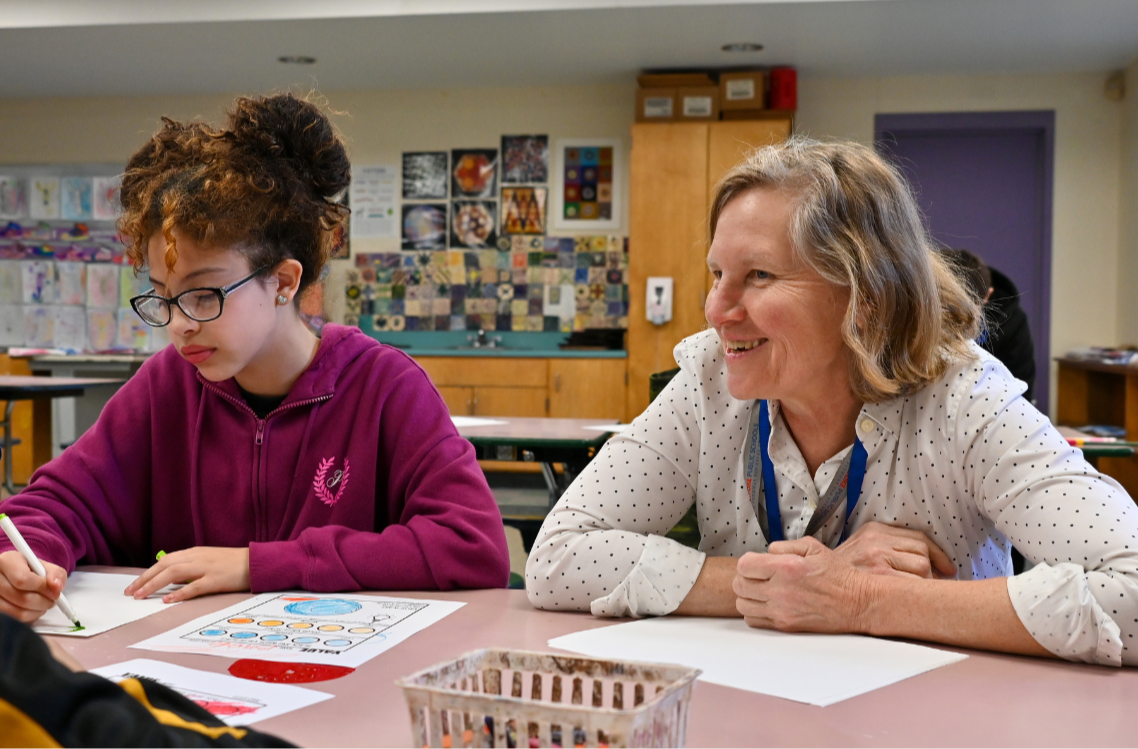 Donahue art teacher Lora Talbot engages with her students during class