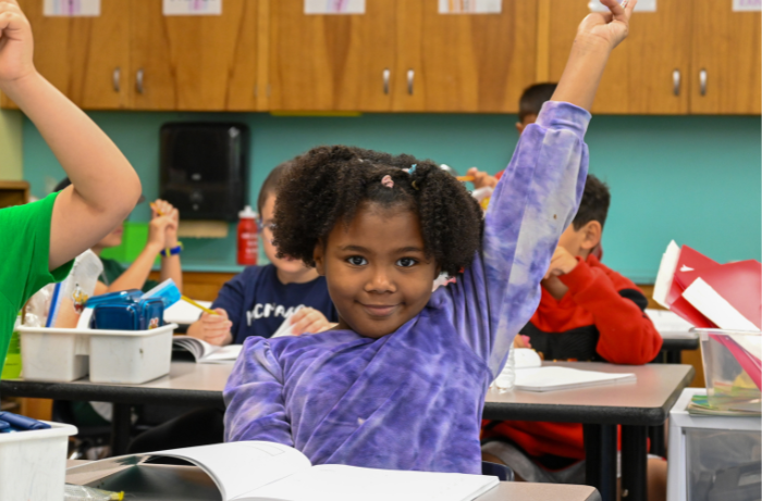 A McMahon student confidently raises her hand—"HERE!"