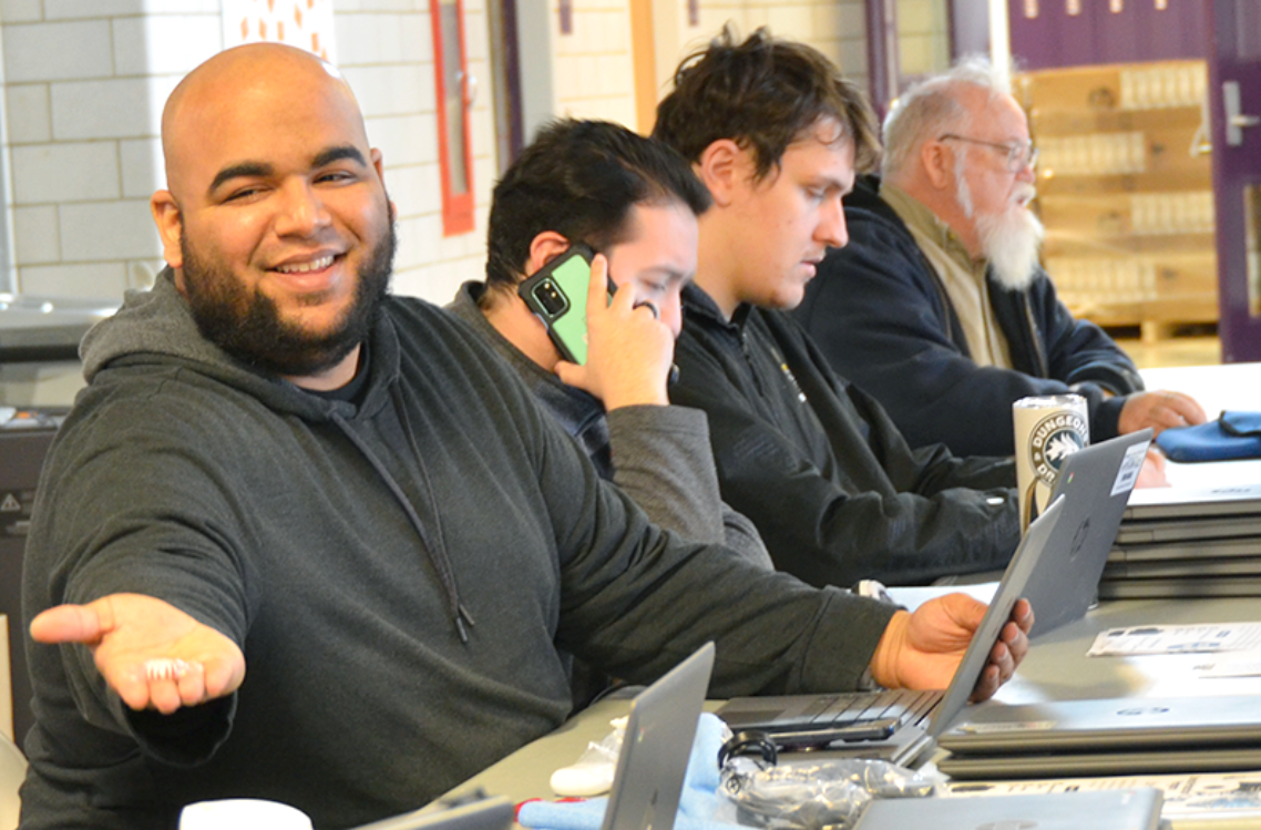 The HPS technology team facilitates the distribution of Chromebooks for high school students