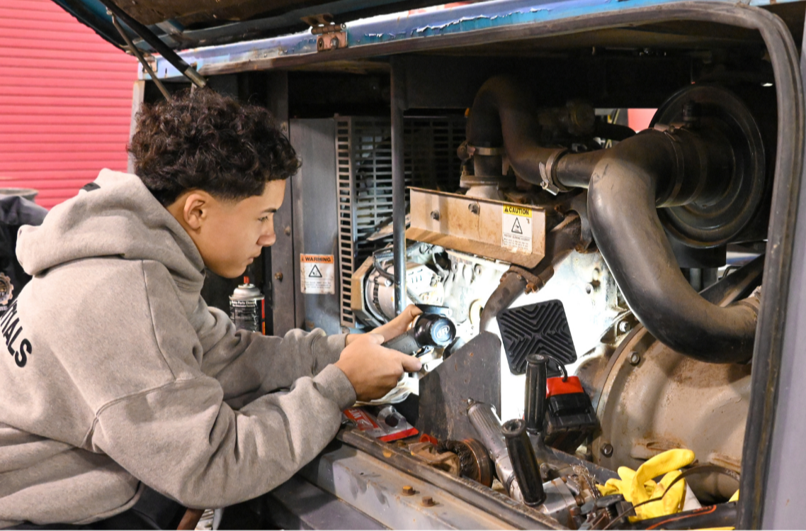 A student at HHS Dean has the opportunity to work on a real diesel engine during in his shop