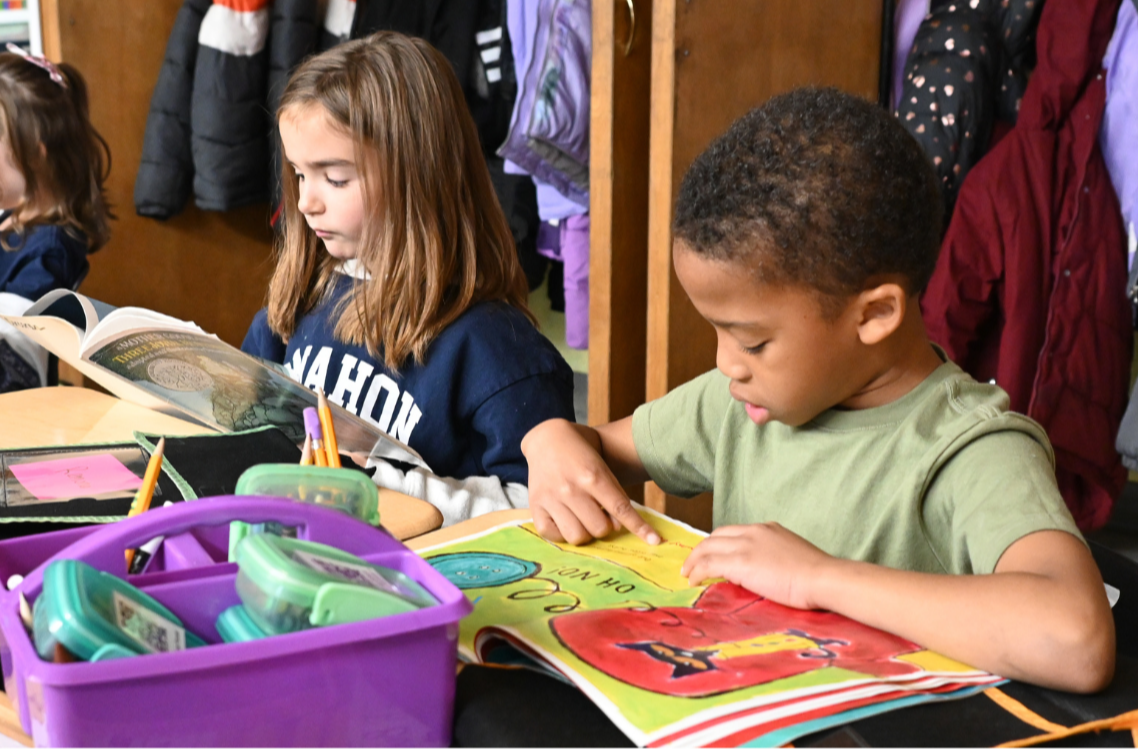 Two McMahon students read books of their choice during quiet reading time