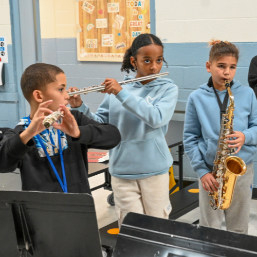 A group of students practice wind instruments