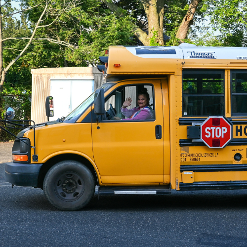 Students walking towards the buses lined outside of school.